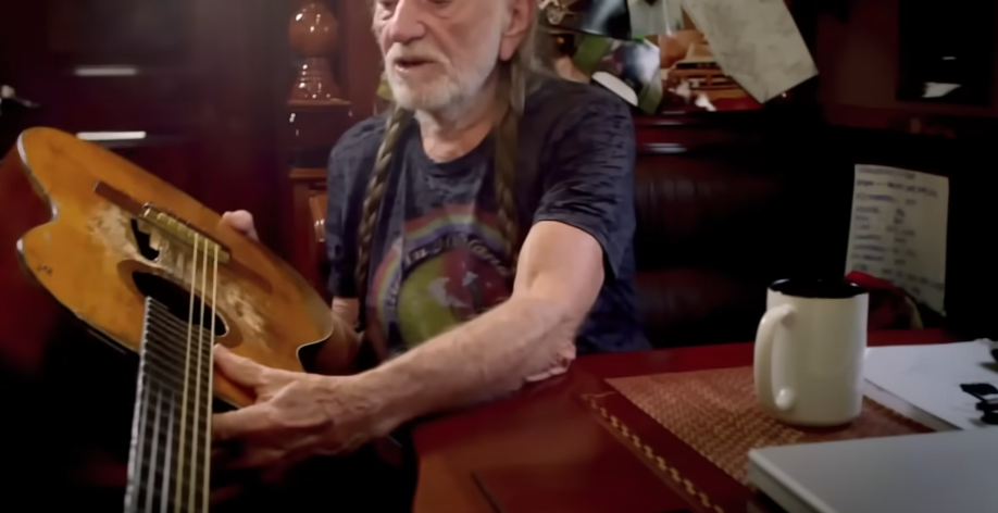 Willie Nelson showing the hole on his guitar on the documentary "Willie Nelson and His Famous Guitar: The Tale of Trigger," dated February 11, 2015 | Source: Youtube/Rolling Stone
