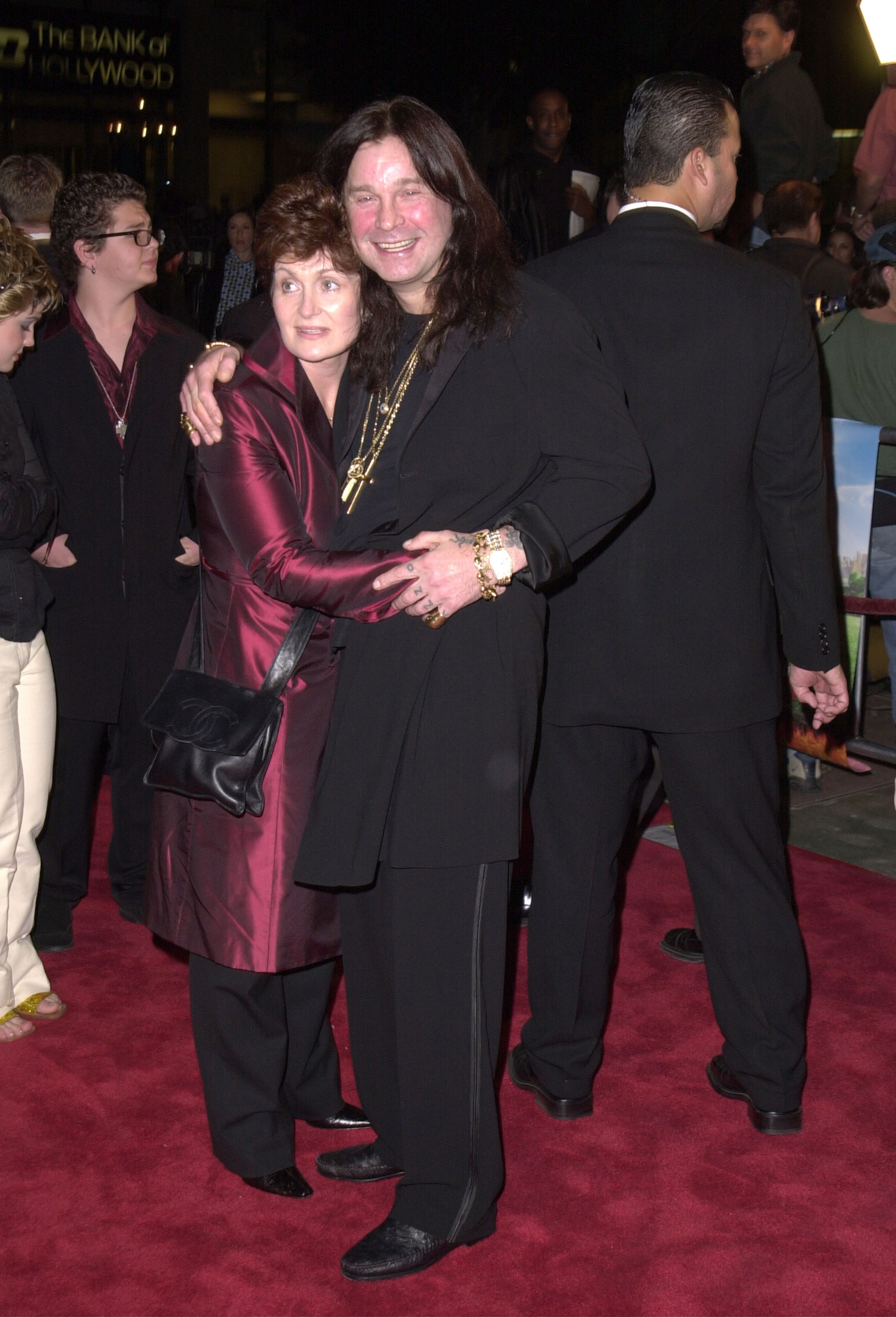 Sharon and Ozzy Osbourne attending the premiere of "Little Nicky" at Mann Chinese Theater in Hollywood, California on November 2, 2000, with Jack Osbourne in the background. | Source: Getty Images