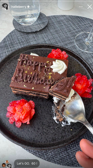 Halle Berry marked her milestone birthday with a decadent chocolate cake topped with strawberries and a simple "Happy Birthday" message. Her "Let's Go. 60!" note made it clear she was more than ready to embrace the next chapter. | Source: Instagram/halleberry