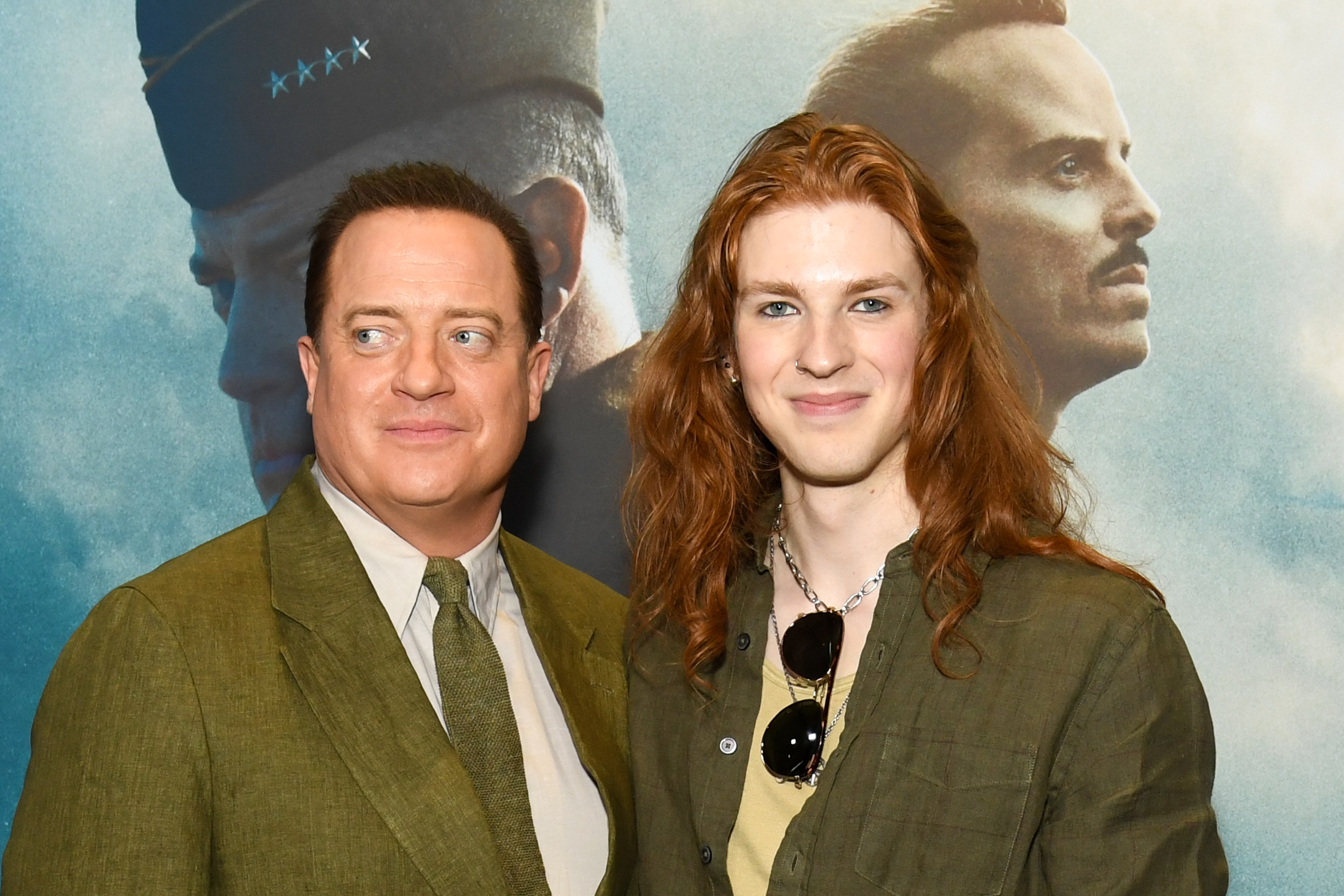 Brendan Fraser posed alongside his youngest son, Leland Fraser, at the New York premiere of "Pressure" at AMC Lincoln Square 13 on May 26, 2026. The father and son coordinated in earthy tones, with Brendan wearing an olive suit while Leland paired an olive overshirt with a lighter top and layered necklaces. At 20, Leland also showed off his long red hair, nose ring, and other jewelry during the rare public appearance supporting his father's latest film.