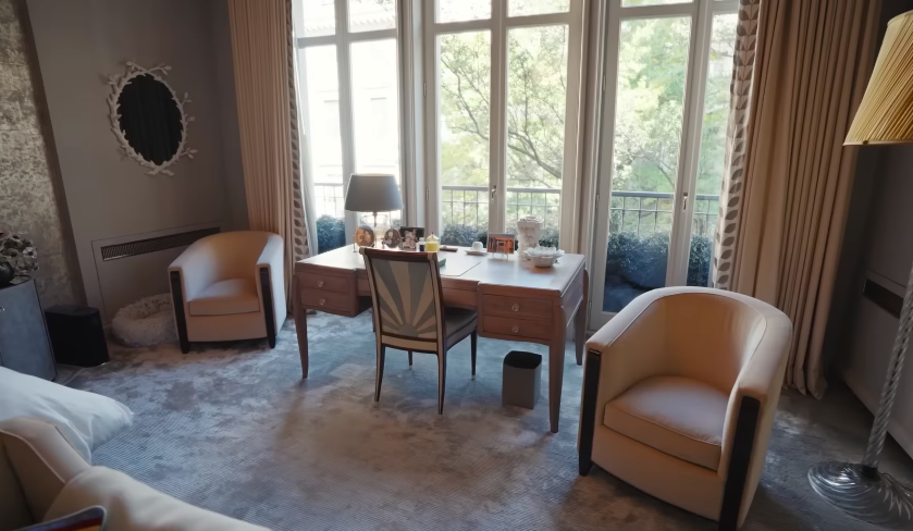 The primary bedroom's seating and desk area show the quieter side of the townhouse. After the darker, more theatrical rooms, this space feels calm, soft, and deeply comfortable. | Source: YouTube/Architectural Digest