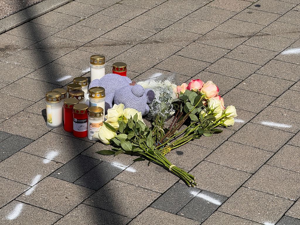People leave flowers and candles at the site of the incident | Source: Getty Images