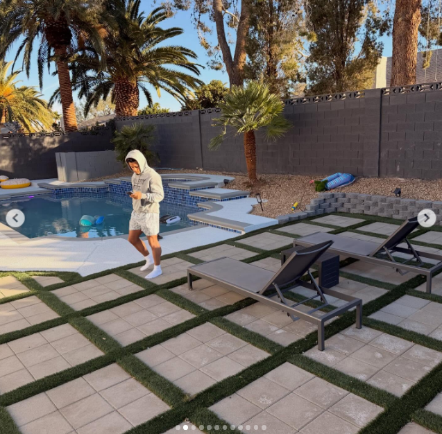 Rondale Moore looking at his phone while walking near a pool, from a post dated February 18, 2026 | Source: Instagram/rondale_moore