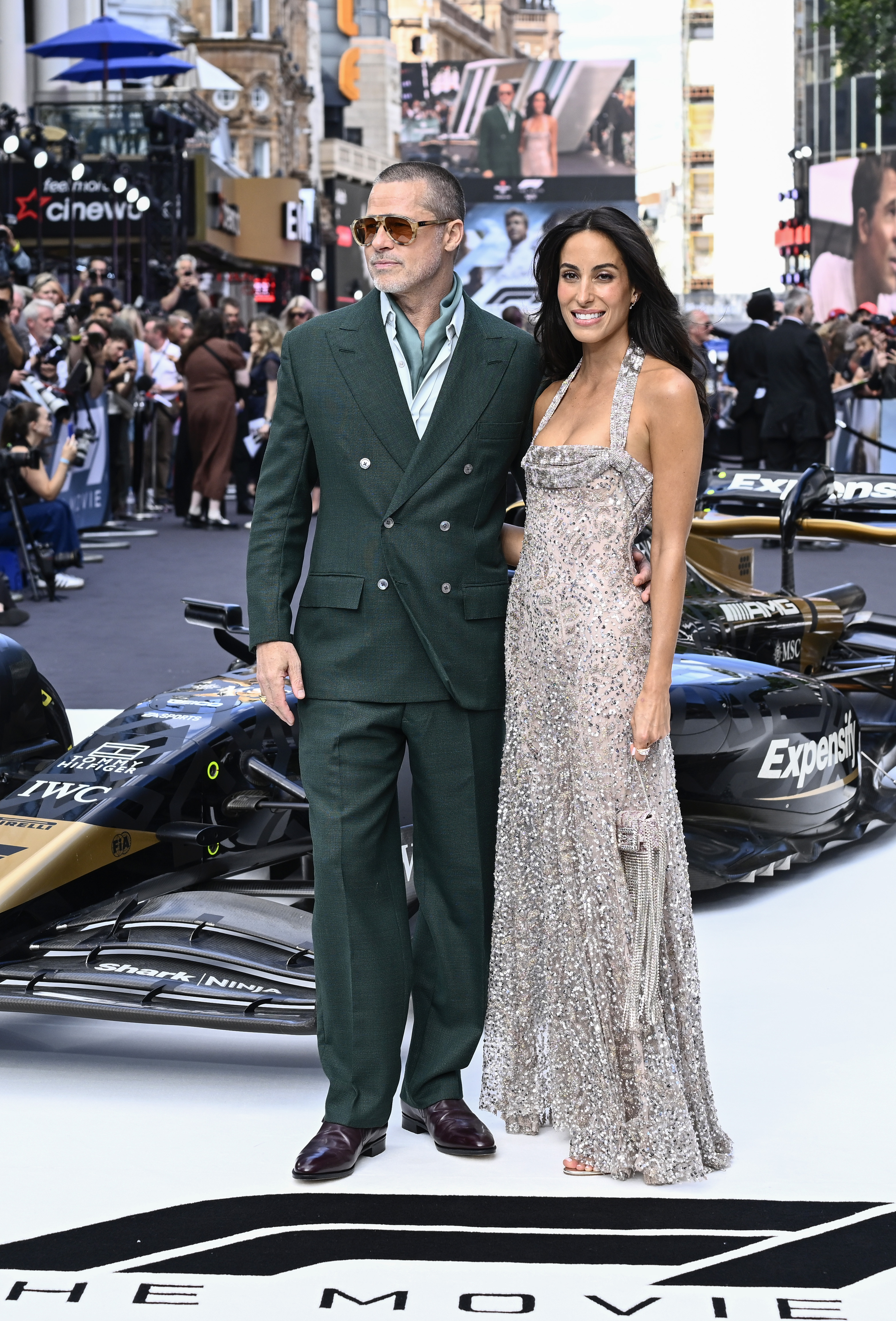 Brad Pitt and Ines de Ramon pose in front of an F1 race car at the premiere of "F1: The Movie" in London on June 23, 2025 | Source: Getty Images