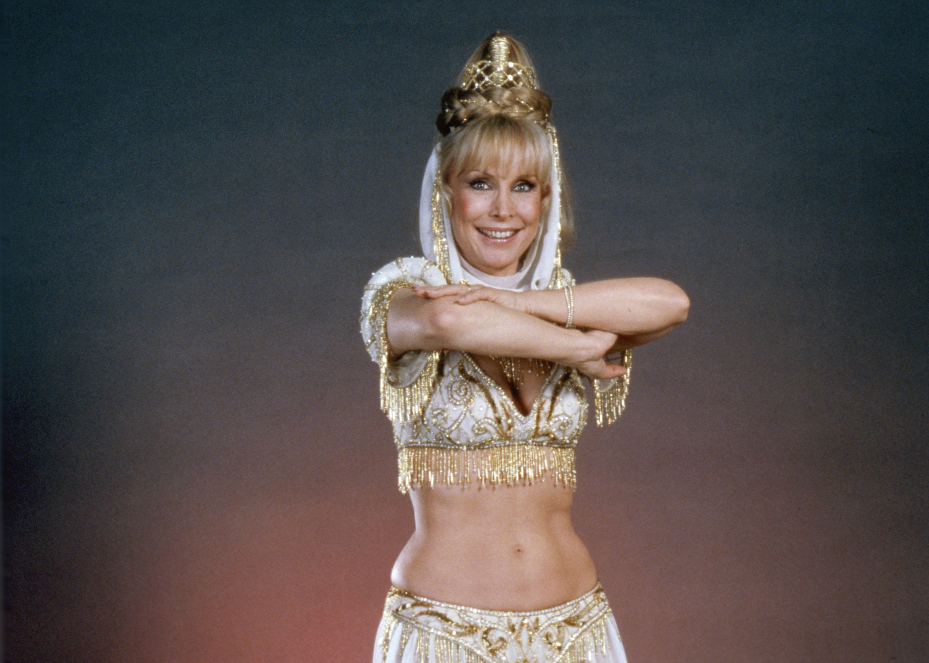 Barbara Eden reprises her role as Jeannie in the television film "I Dream of Jeannie: 15 Years Later," wearing the character's signature midriff-baring costume, which aired on October 20, 1985. | Source: Getty Images