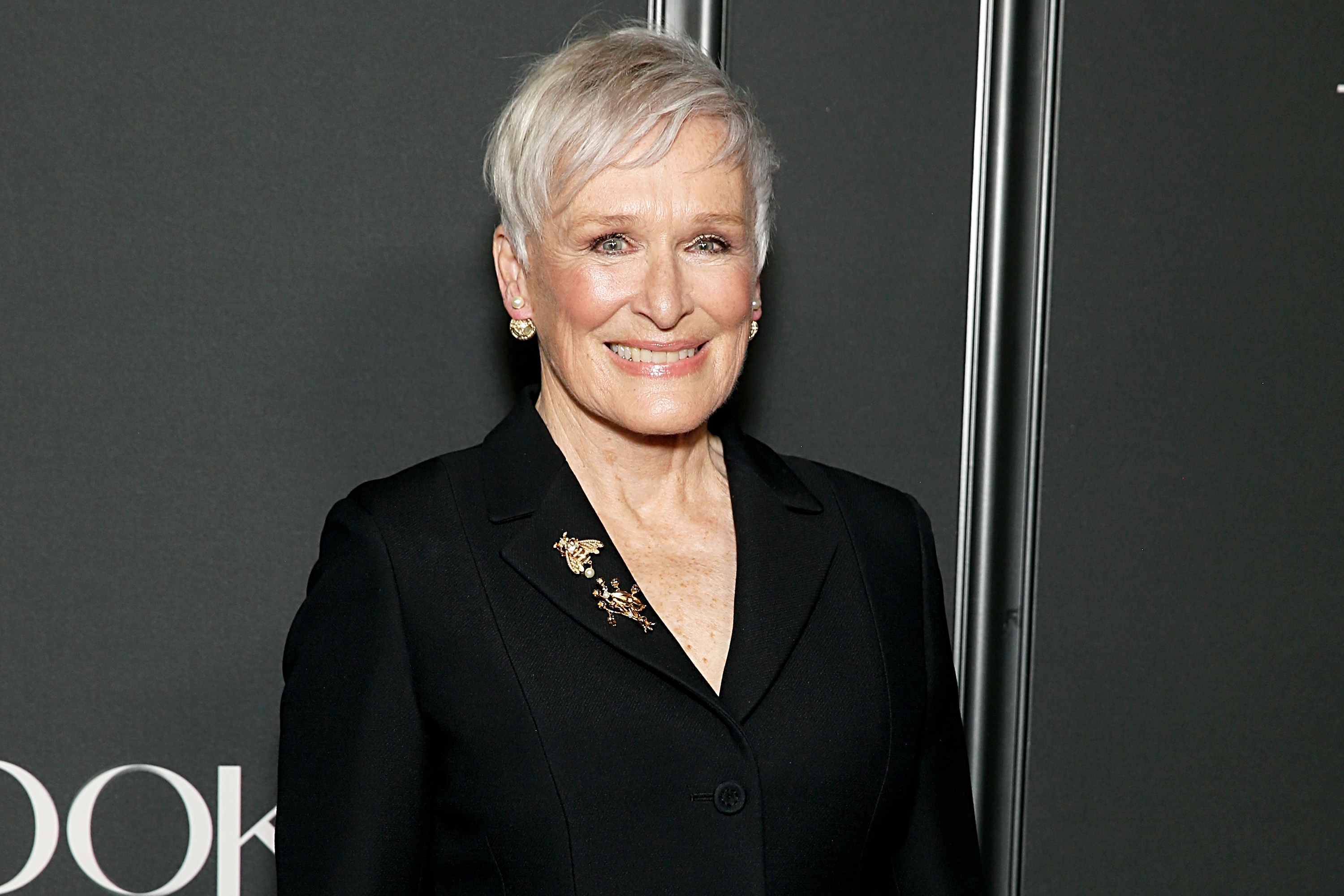 Glenn Close wears her short silver hair in a textured, side-swept style at a February 2024 premiere in New York City. Her hairstyle shows how gray hair can remain part of a polished red-carpet look without hiding its natural color. | Source: Getty Images