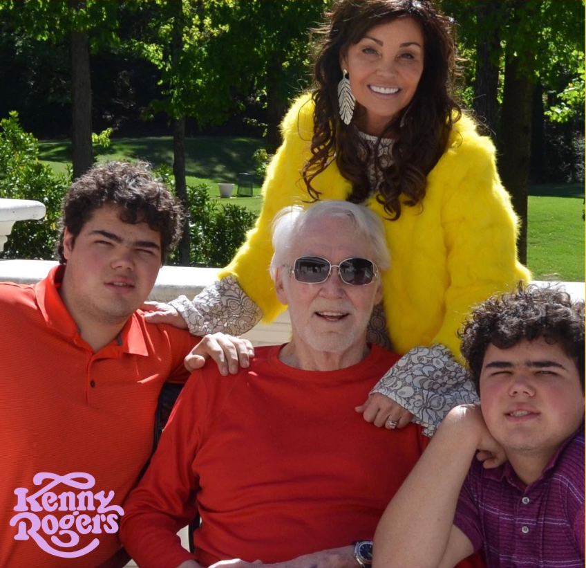 This family photo shows Kenny Rogers surrounded by Wanda Miller and their twin sons, Justin and Jordan, capturing the later-in-life fatherhood that brought him immense joy despite his fears about missing the boys' future milestones. | Source: Facebook/Kenny Rogers