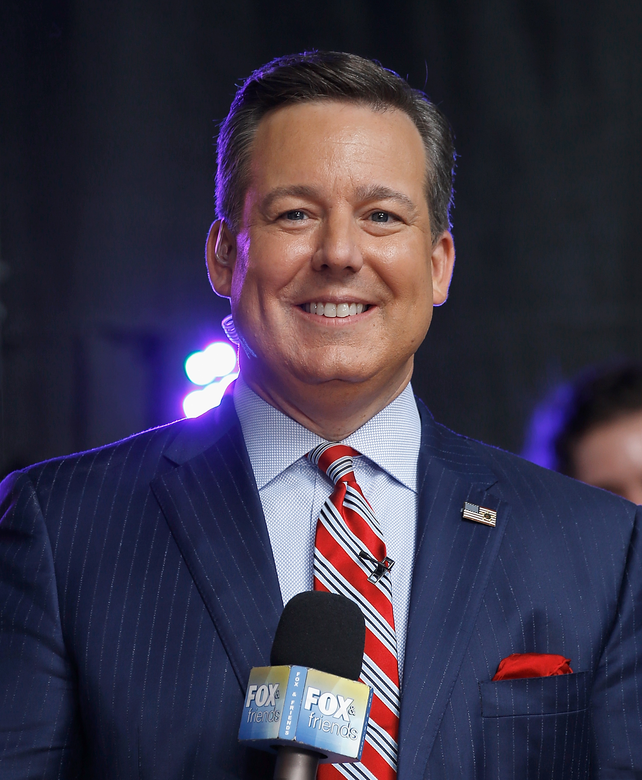 Ed Henry attends an event in 2018 while representing Fox News, holding a Fox & Friends microphone. | Source: Getty Images