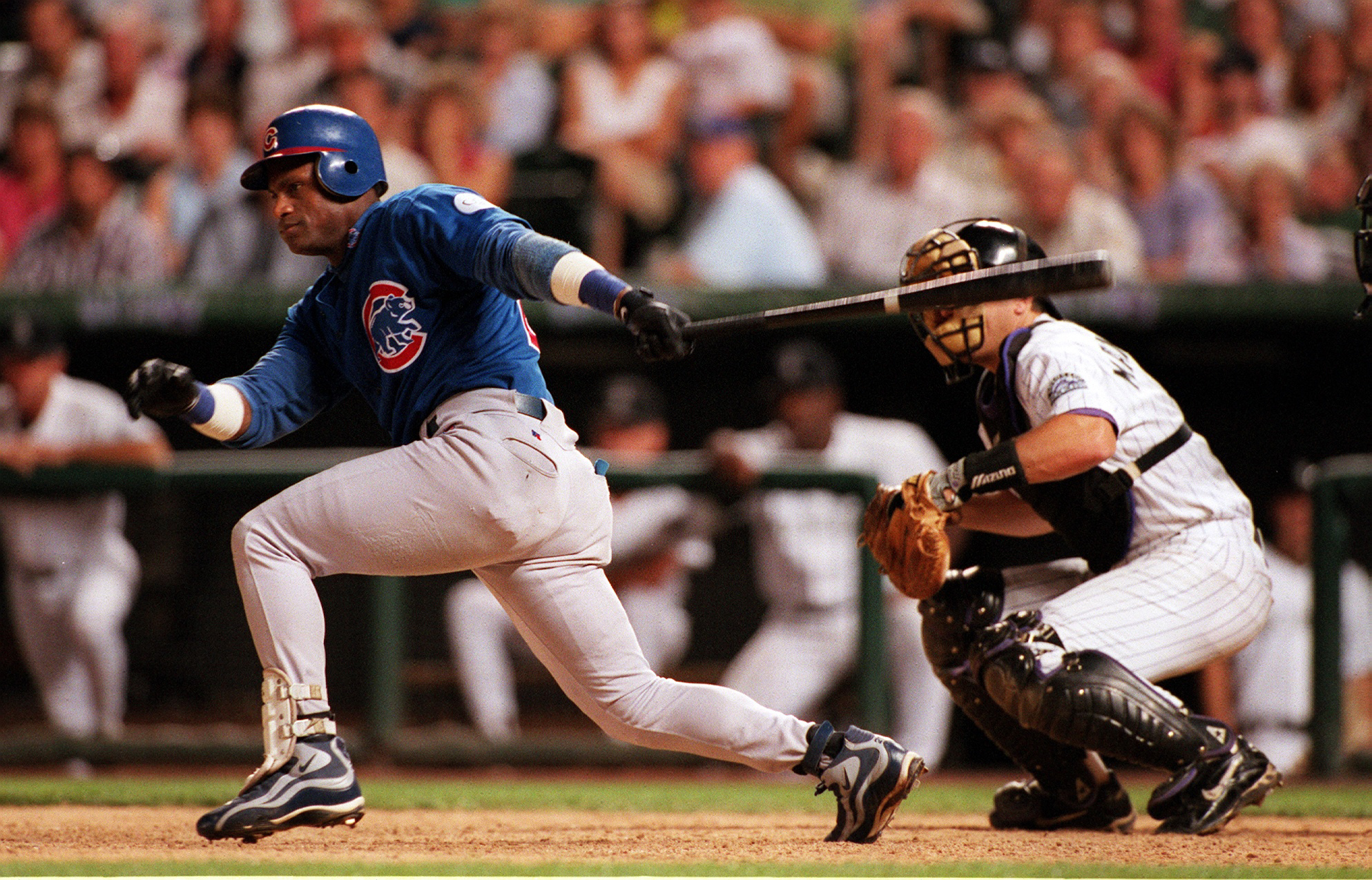 Sammy Sosa powered through his swing as the Chicago Cubs faced the Colorado Rockies on August 29, 1998, with the catcher crouched behind home plate and a packed crowd watching from the stands. Sosa recorded a ninth-inning single during a season that became one of the defining chapters of his career, as his home-run race with Mark McGwire captivated baseball fans across the country.