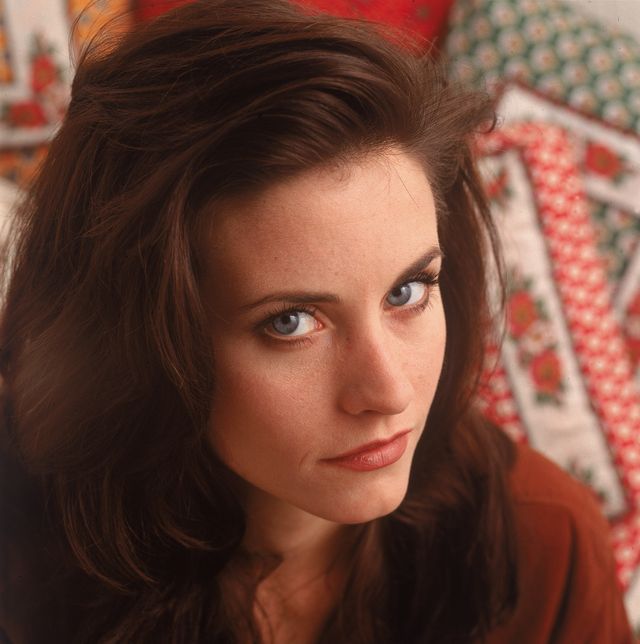 Courteney Cox gazes at the camera in 1992 at 28 years old, two years before her hit show "Friends" first aired.
