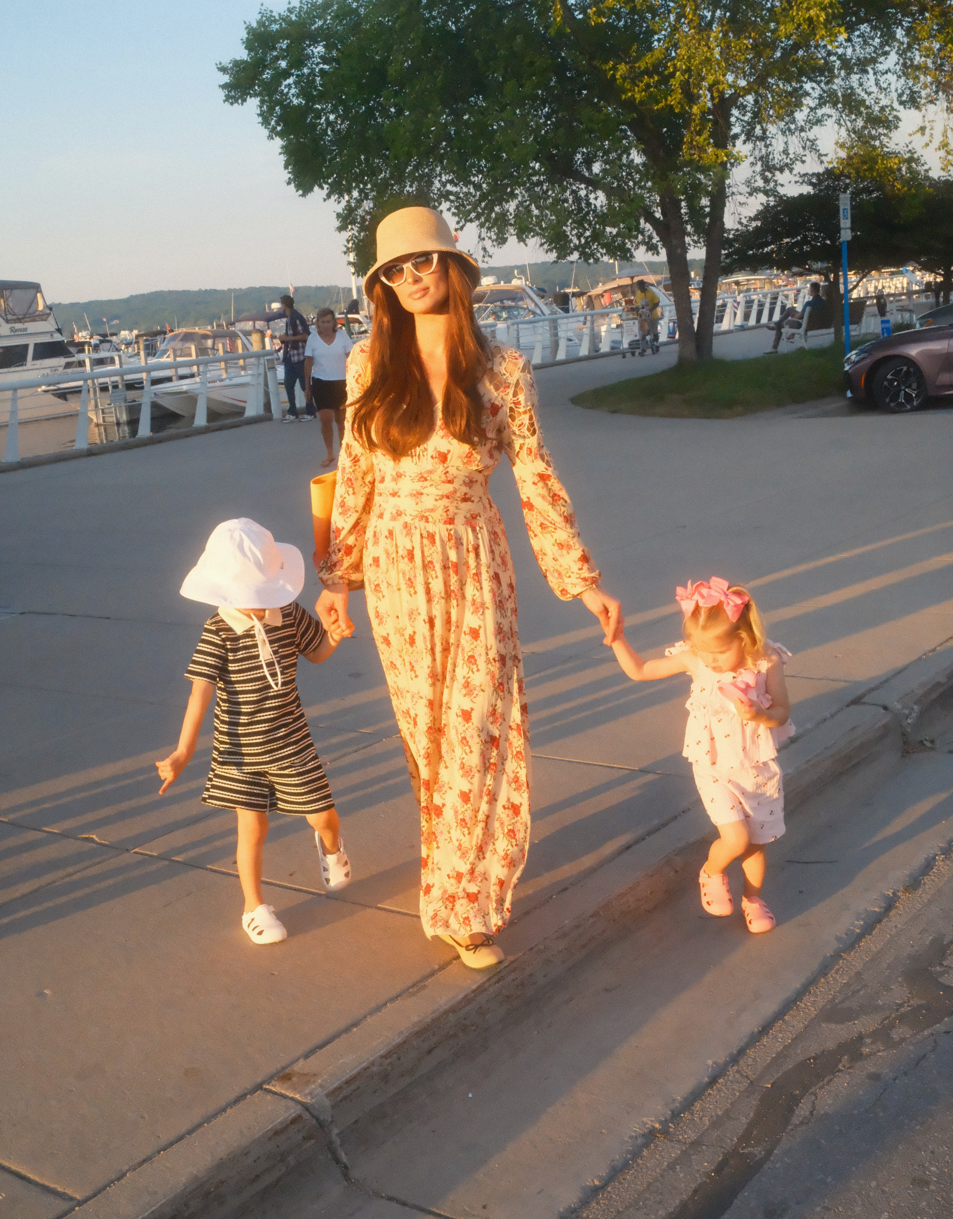 Away from the busiest attractions, Paris appeared to enjoy a low-key walk with both children. Fans later speculated that her brunette transformation may have allowed her to move through the festival largely unnoticed. | Source: Instagram/parishilton