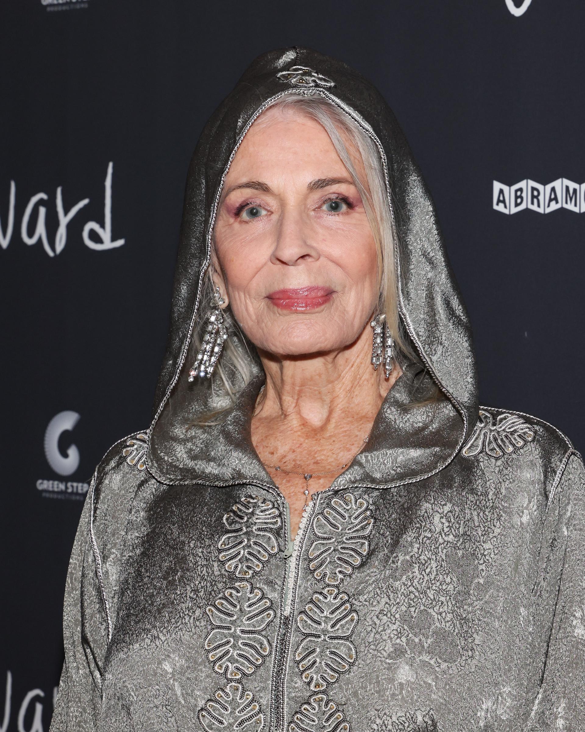 Joanna Cassidy attends the 2024 Los Angeles premiere of "Wayward" in a metallic hooded ensemble with embroidered detailing and statement earrings. The appearance highlights the veteran actress's distinctive red carpet style. | Source: Getty Images