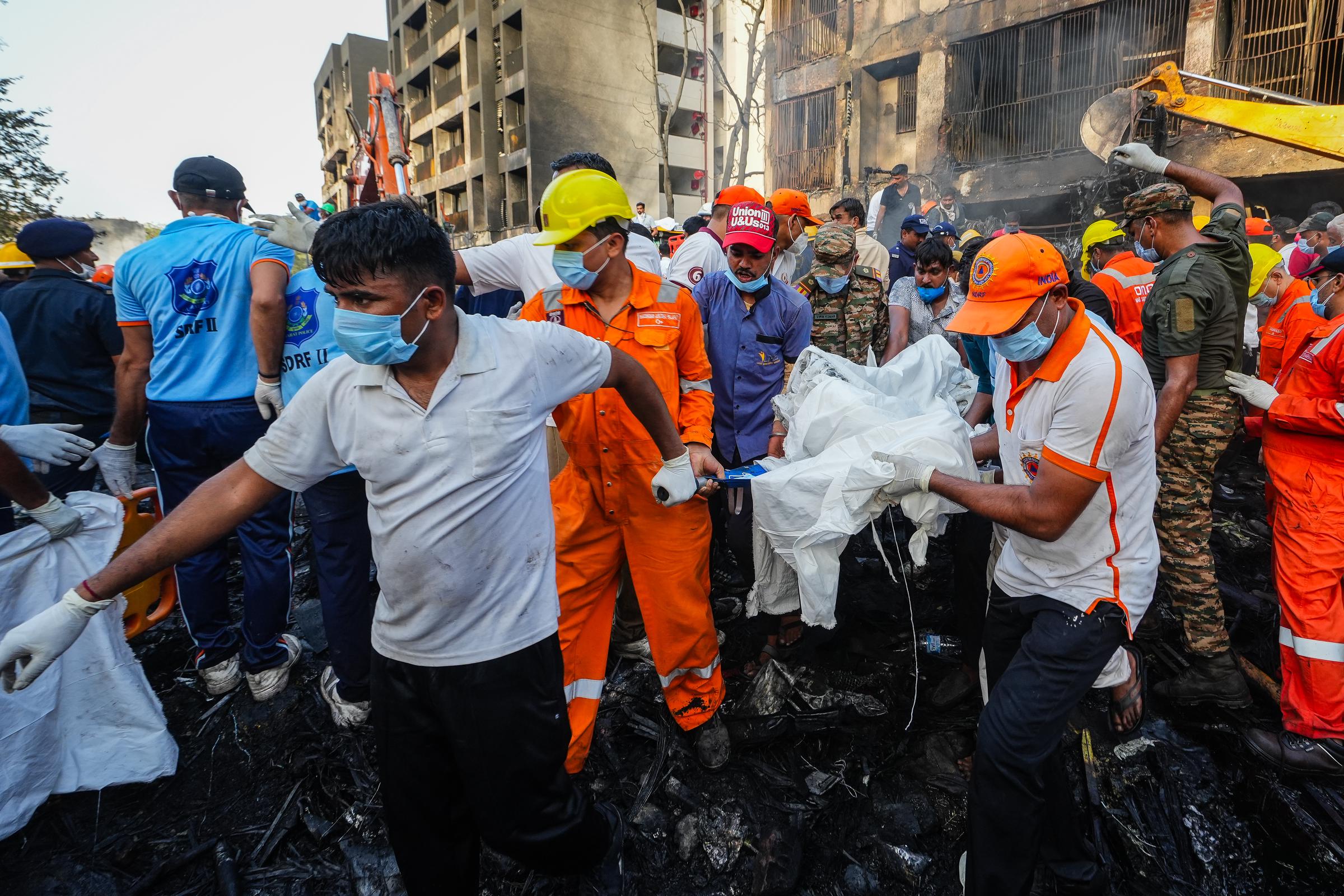 Rescue workers handle recovery operations at the Air India crash site in Ahmedabad.| Source: Getty Images