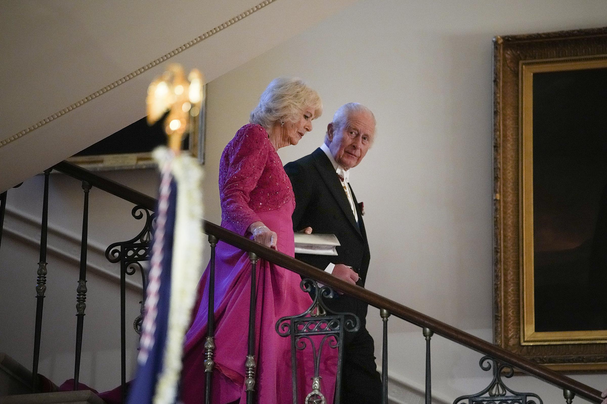 Queen Camilla and King Charles III walk down a staircase during the White House state dinner in Washington, D.C. on April 28, 2026 | Source: Getty Images