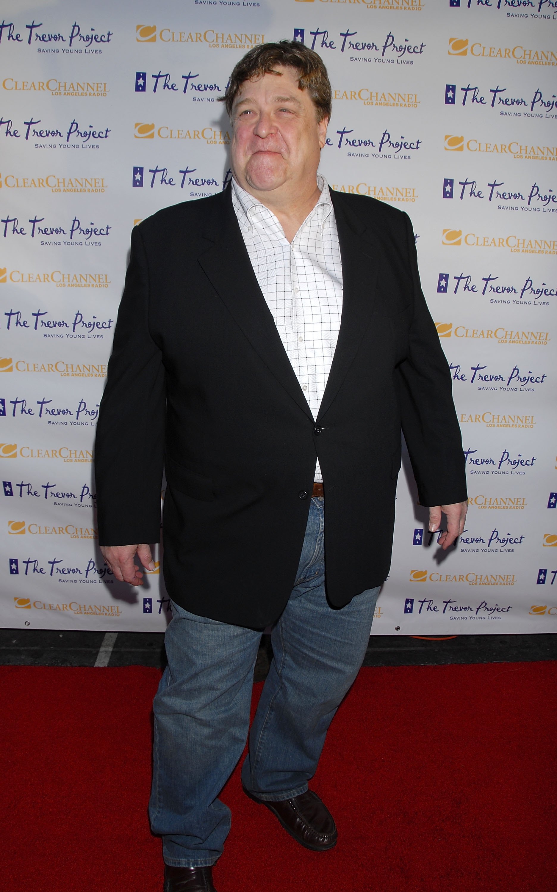 Goodman arrived at the Trevor Project's 9th annual Cracked XMas "Mistletoe, Mischief & Myrrh!" event, dressed in his signature denim trousers worn on a white patterned shirt and a black suit jacket. He also sported his signature grin-like smile.