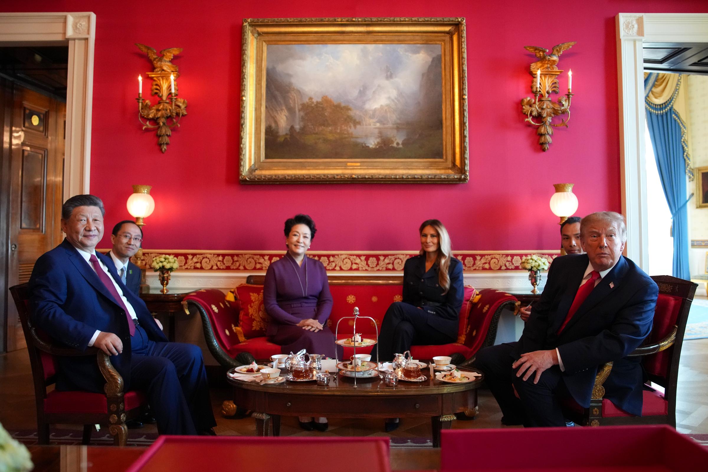 A stately diplomatic encounter unfolded inside the Red Room of the White House as Donald Trump and First Lady Melania Trump hosted Chinese President Xi Jinping and First Lady Peng Liyuan for a traditional tea ceremony on September 25, 2026, in Washington, DC. Gathered beneath a grand landscape oil painting, the leaders and their spouses sat around a low table laid with teapots, cups, and a multi-tiered dessert stand, with Peng elegant in a deep purple ensemble and Melania in a sharp black Ralph Lauren pantsuit as the three-day state visit drew to a close. | Source: Getty Images