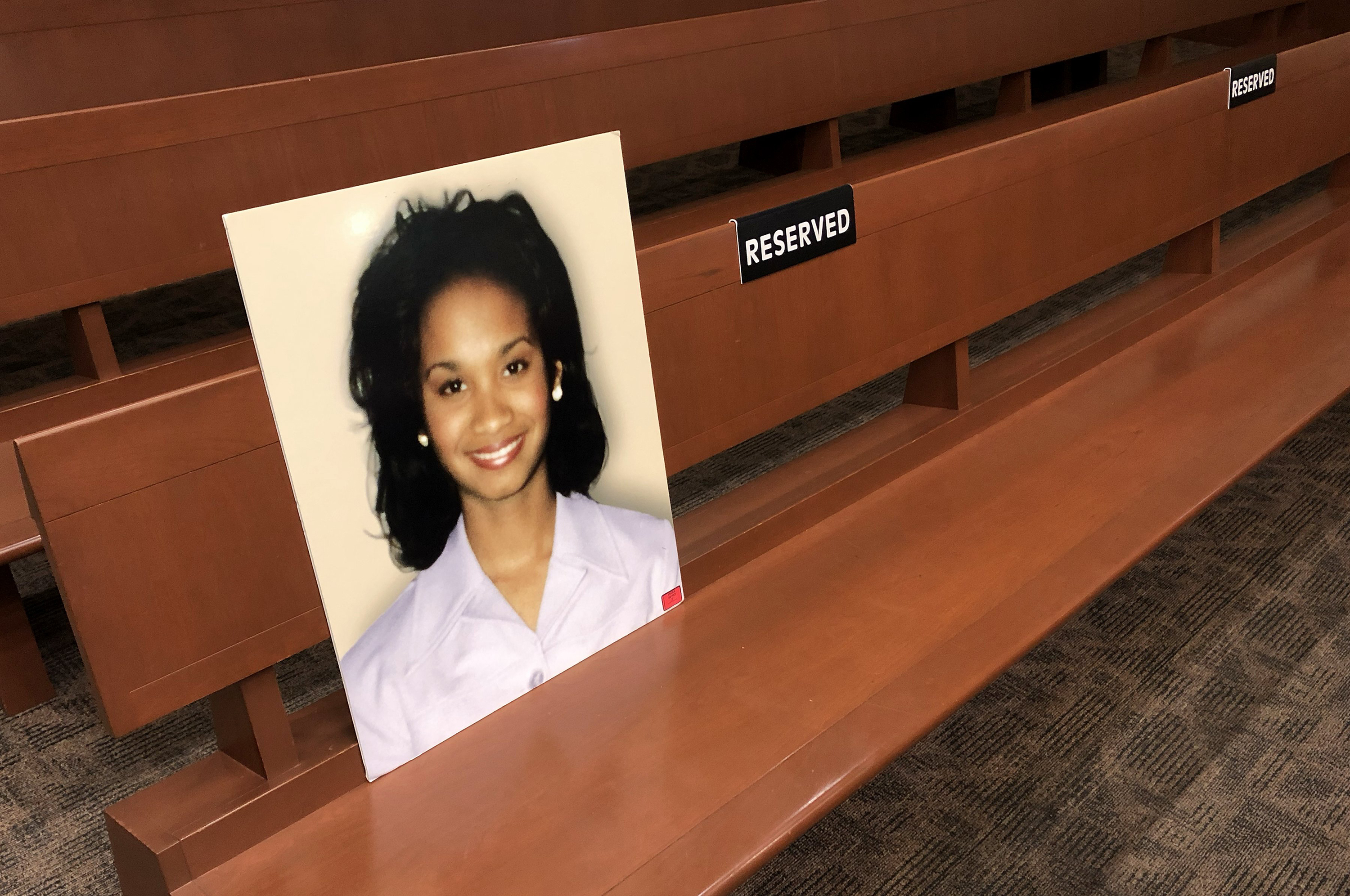 A photograph of Cherica Adams rested against a courtroom bench at the Mecklenburg County Courthouse in Charlotte, North Carolina, on July 26, 2024. Preserved as evidence and stored at the courthouse, the portrait showed Cherica smiling, offering a quiet reminder of the 24-year-old mother whose life was cut short after she was shot while pregnant with her son, Chancellor Lee Adams.