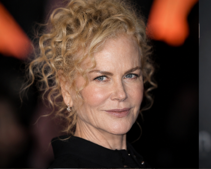 Imagining a world where Kidman never touched a syringe, this look embraces her iconic, tightly coiled curls from the start of her career, paired with a soft, completely mobile complexion that shows realistic crinkling around the eyes and a natural jawline free of synthetic volume. | Source: Midjourney