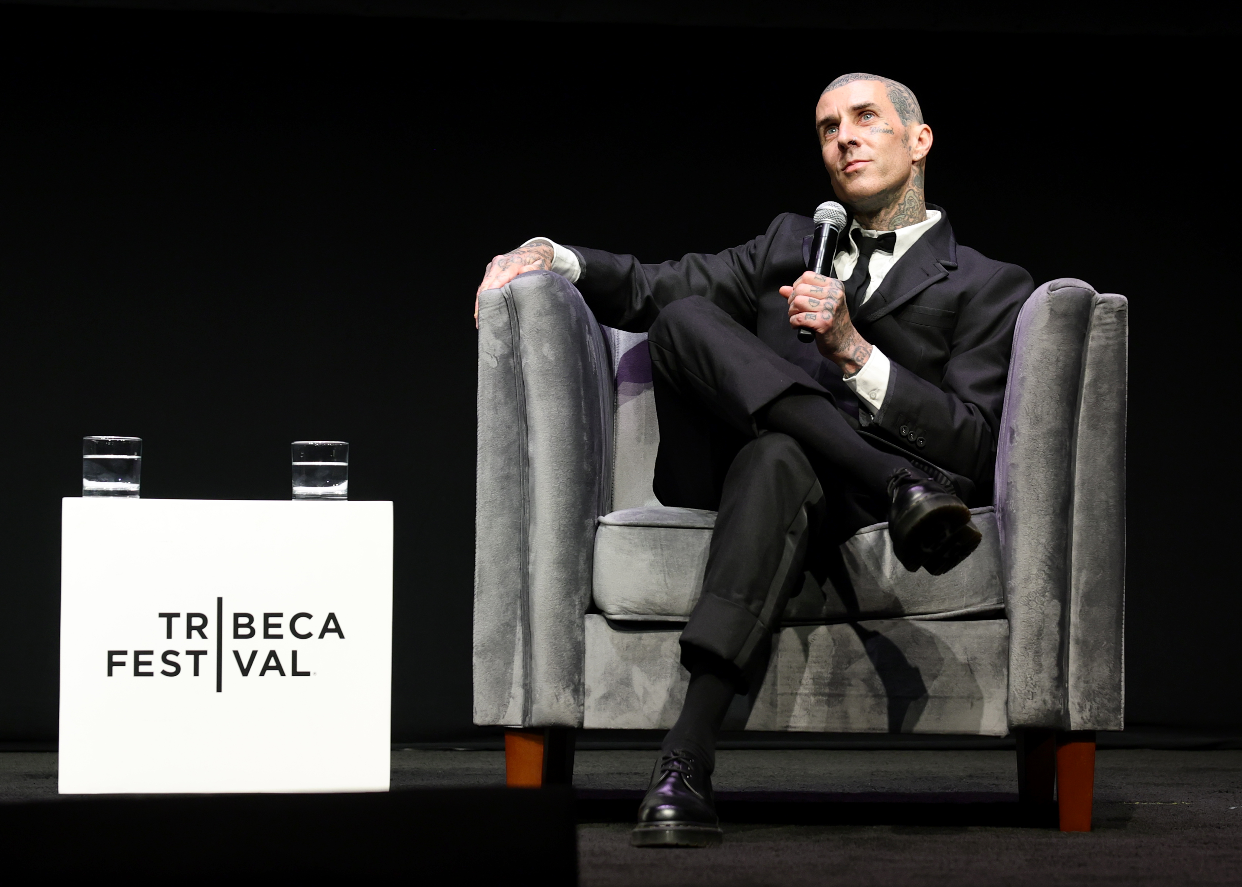 Travis Barker speaks onstage during the "Travis Barker: Louder Than Fear" premiere during the 2026 Tribeca Festival at Spring Studios in New York on June 13. | Source: Getty Images