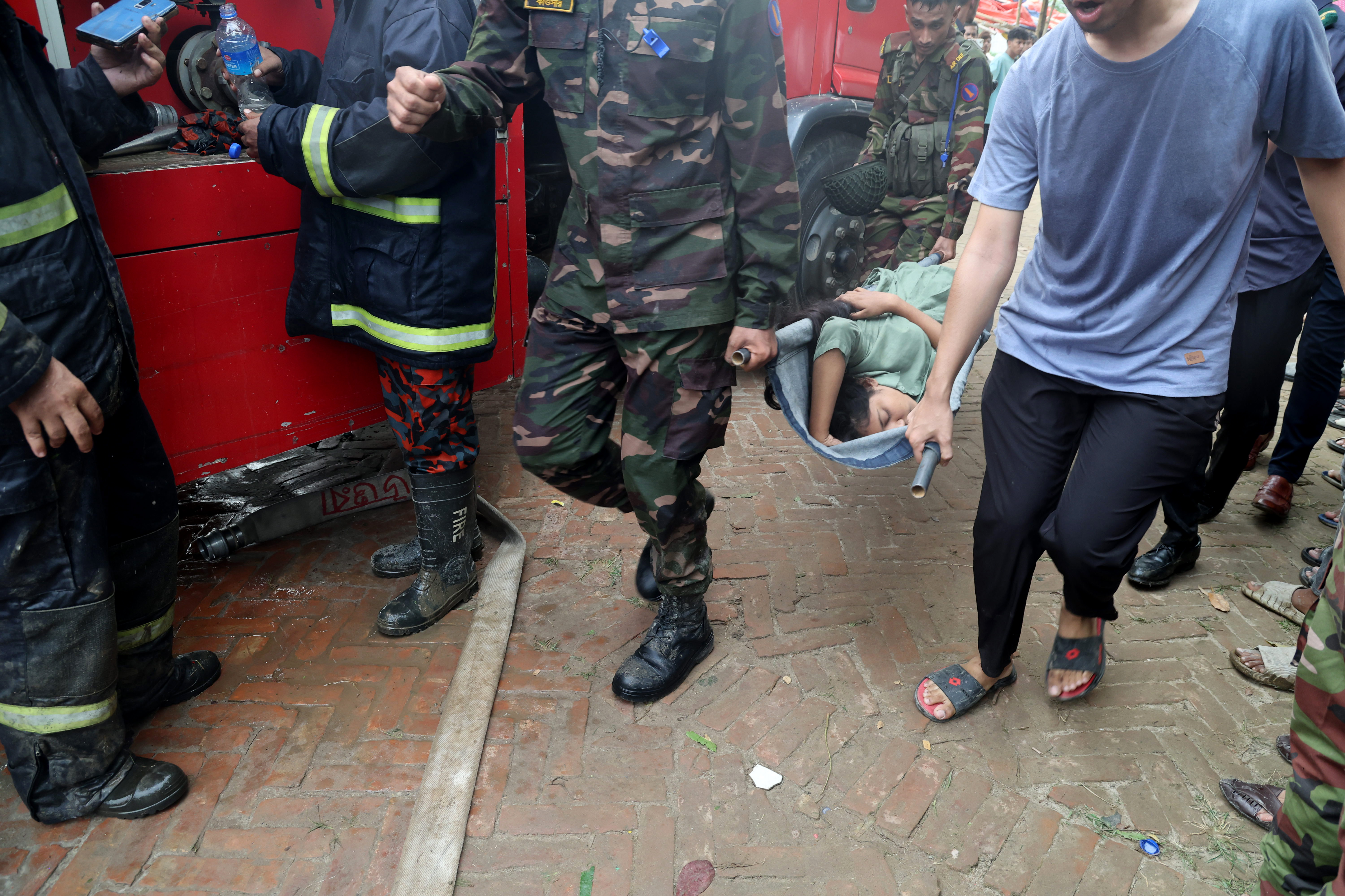 A person being carried out by members of the Bangladesh Army and the fire service after the Bangladesh Air Force F7 aircraft crashed into a building of Milestone College in Dhaka's Uttara around 1:30 pm in Dhaka, Bangladesh on July 21, 2025 | Source: Getty Images