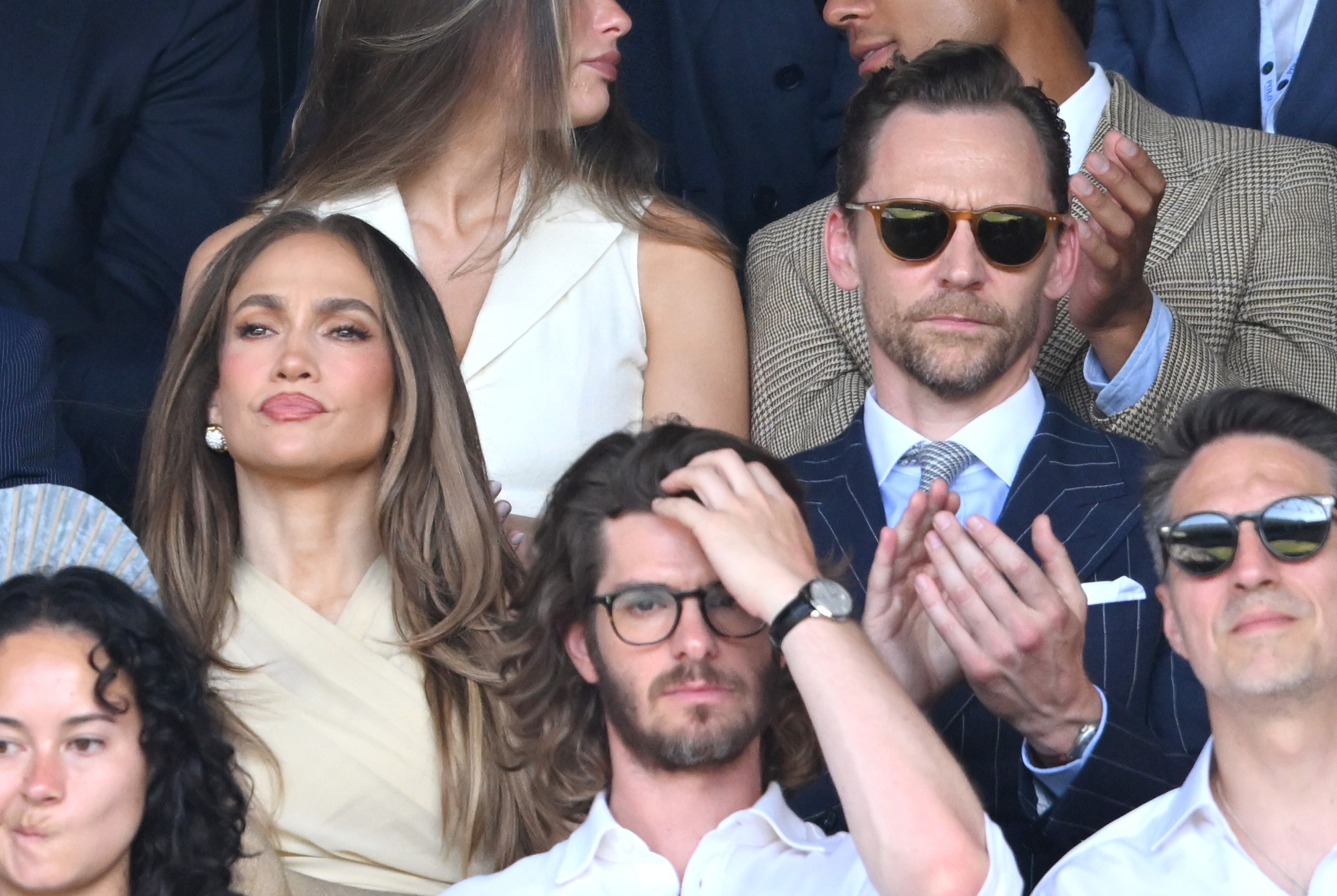 Lopez attended the men's singles final in a cream Ralph Lauren ensemble that balanced understated tailoring with unmistakable star power. Without the controversial accessory, attention shifted to her polished styling and signature caramel-toned waves. | Source: Getty Images
