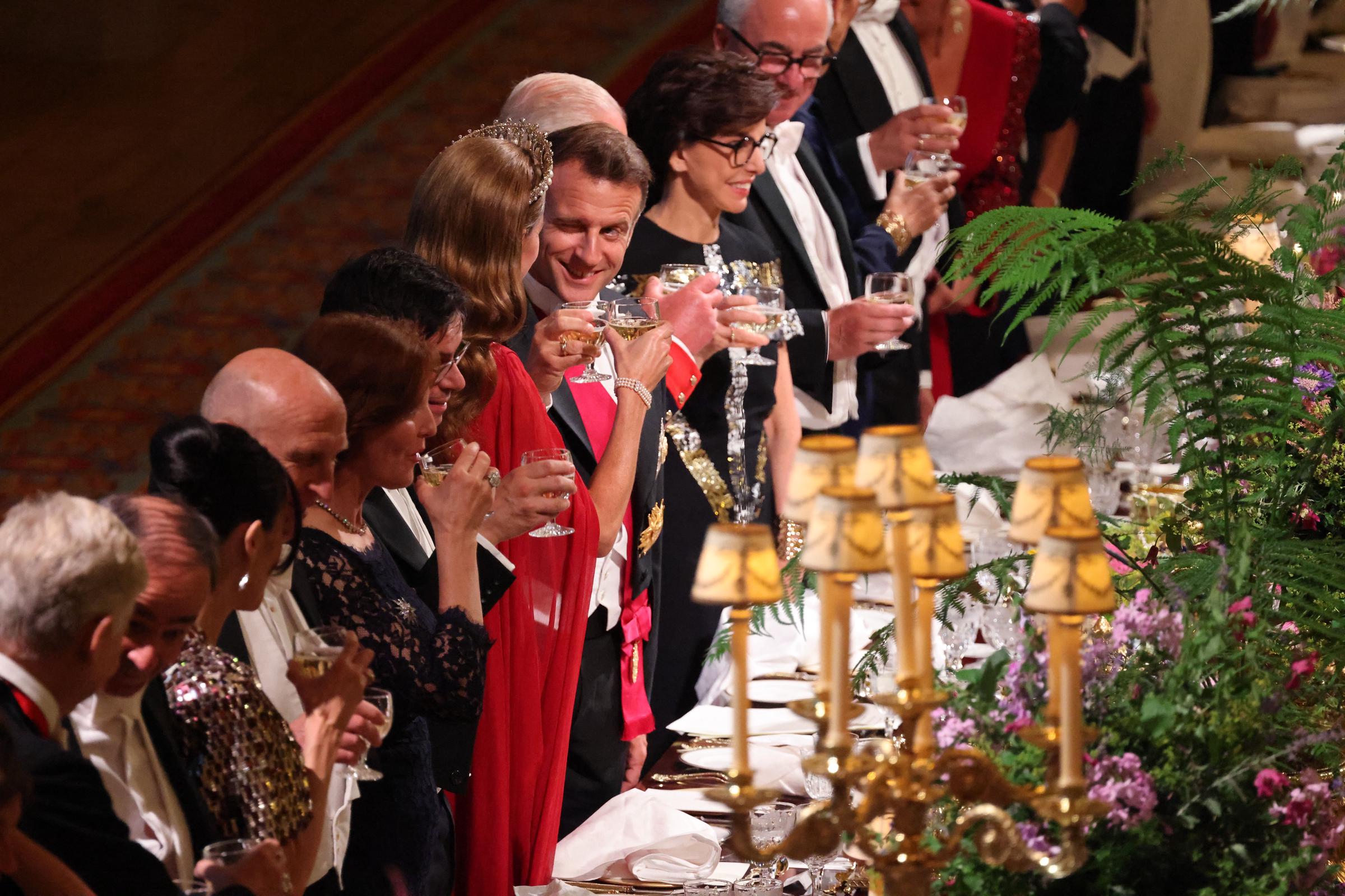 France's President Emmanuel Macron is caught on camera as he winks during a toast with Britain's Princess Catherine of Wales at a State Banquet at Windsor Castle, west of London, on July 8, 2025.