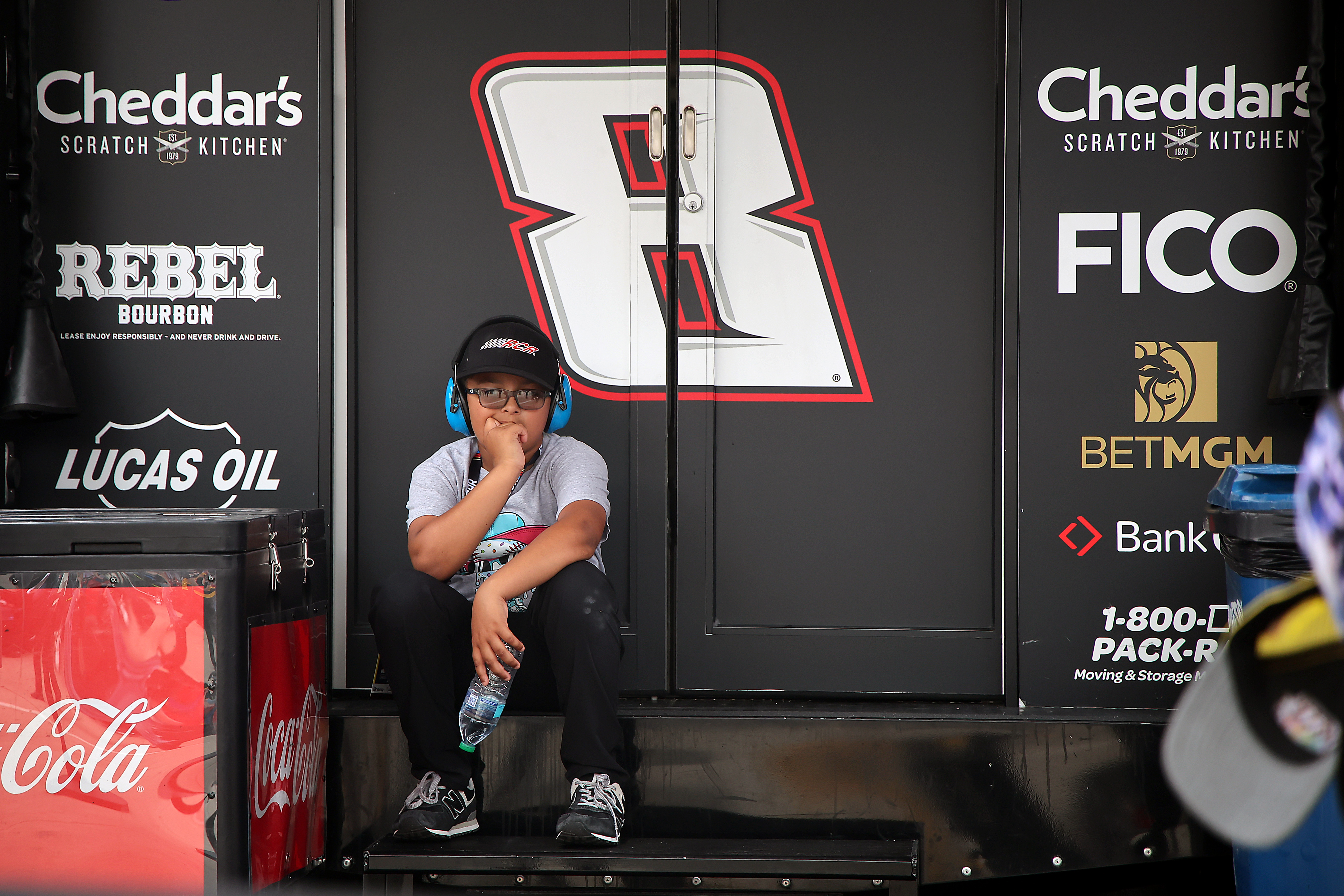 A young NASCAR fan sits on the steps of the #8 hauler, prior to the NASCAR Cup Series Coca-Cola 600 at Charlotte Motor Speedway on May 24, 2026 | Source: Getty Images