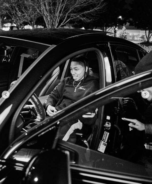 Monica's son, Romelo Hill, sitting in his new car, from a post dated January 13, 2026 | Source: Instagram/monicadenise