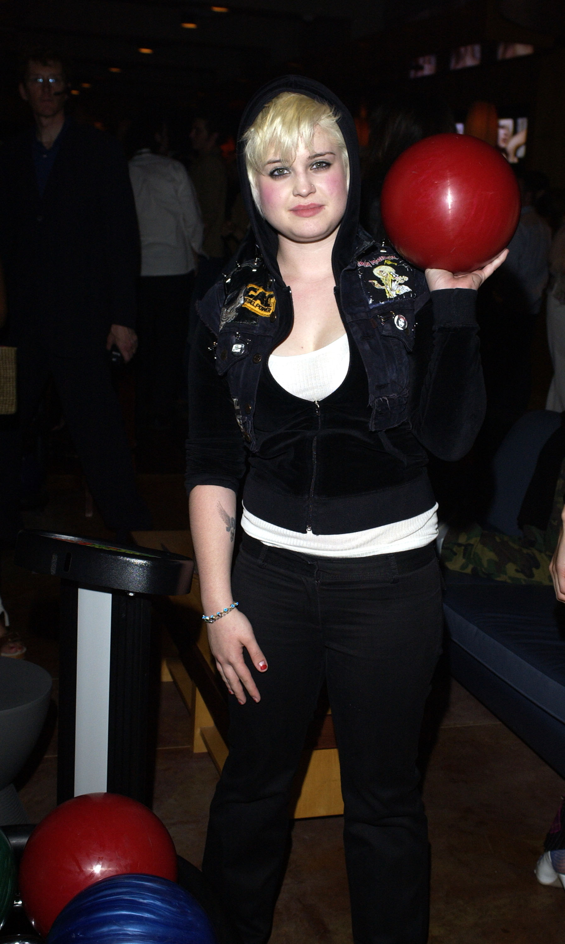 Kelly Osbourne attends the premiere of Lucky Strike Lanes' Bowling Lounge in Hollywood, California, in 2003, showcasing a platinum blonde hairstyle and casual punk-inspired look during one of her most recognizable early-career style phases. | Source: Getty Images