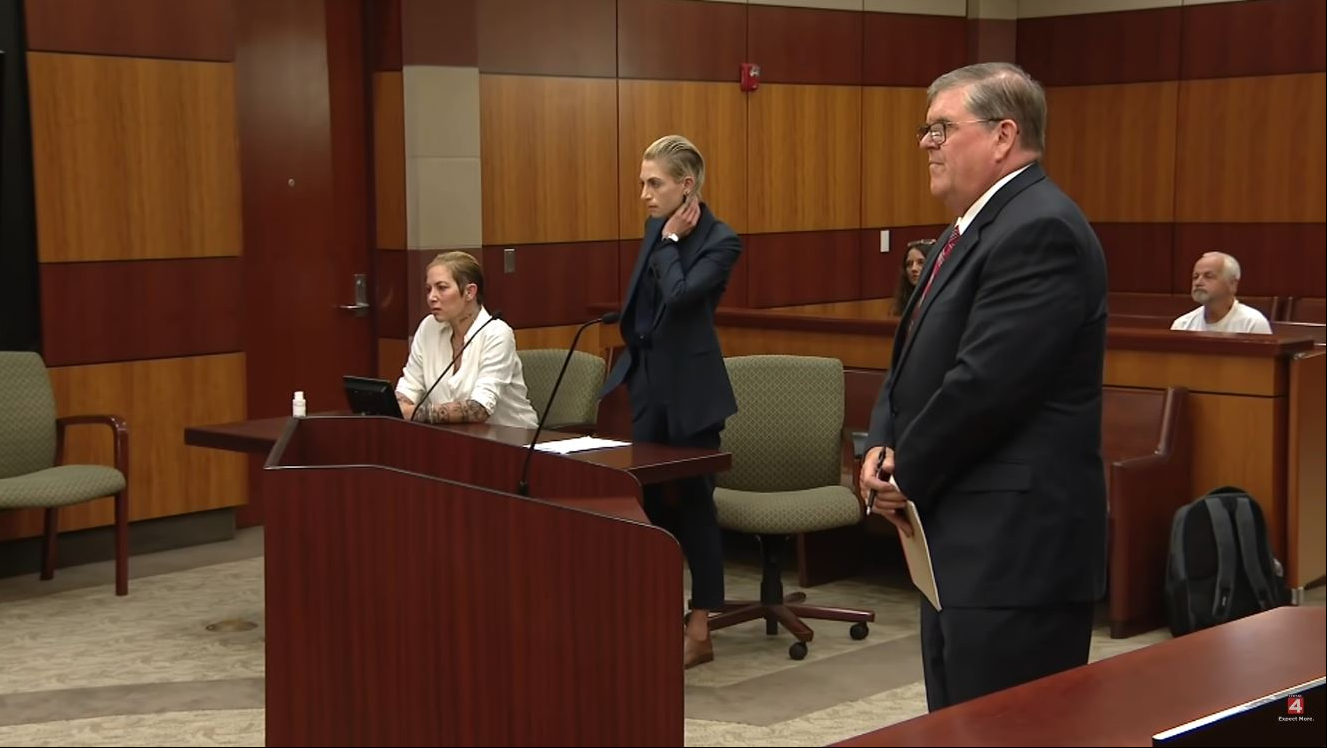 A wider view of the wood-paneled courtroom showed Scott seated at the table in her white shirt while her lawyer stood nearby in a dark suit. The proceedings followed Scott's no-contest plea to an OWI charge and came amid allegations that she had violated the terms of her bond by failing to appear for court hearings. | Source: YouTube/Click On Detroit | Local 4 | WDIV
