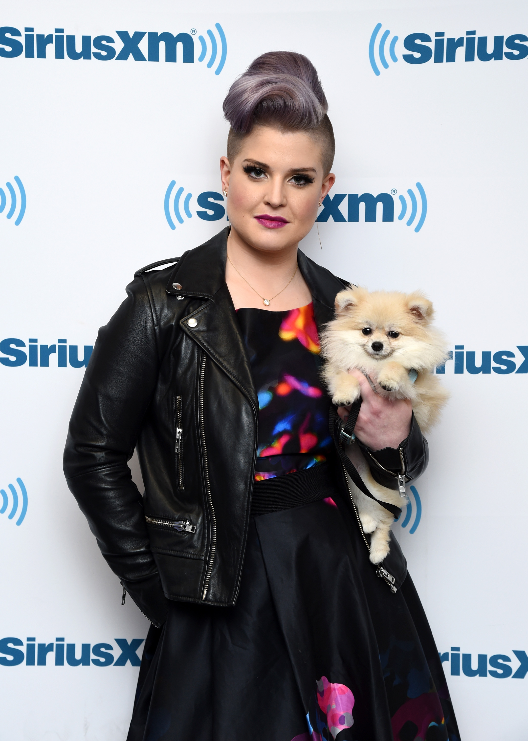 Kelly Osbourne arrives at SiriusXM Studios in 2015, pairing her trademark lavender hairstyle with edgy yet playful fashion, a look that had become one of the most recognizable phases of her style evolution. | Source: Getty Images