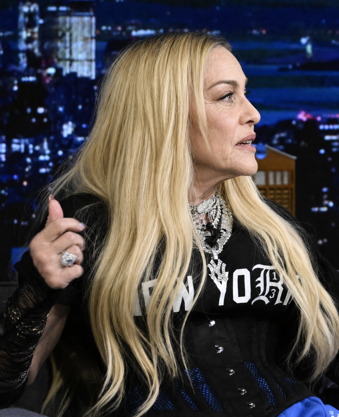 The digitally reworked portrait retains Madonna's long blond hair, jewelry, clothing and seated pose while changing the appearance of her face. | Source: Chat GPT