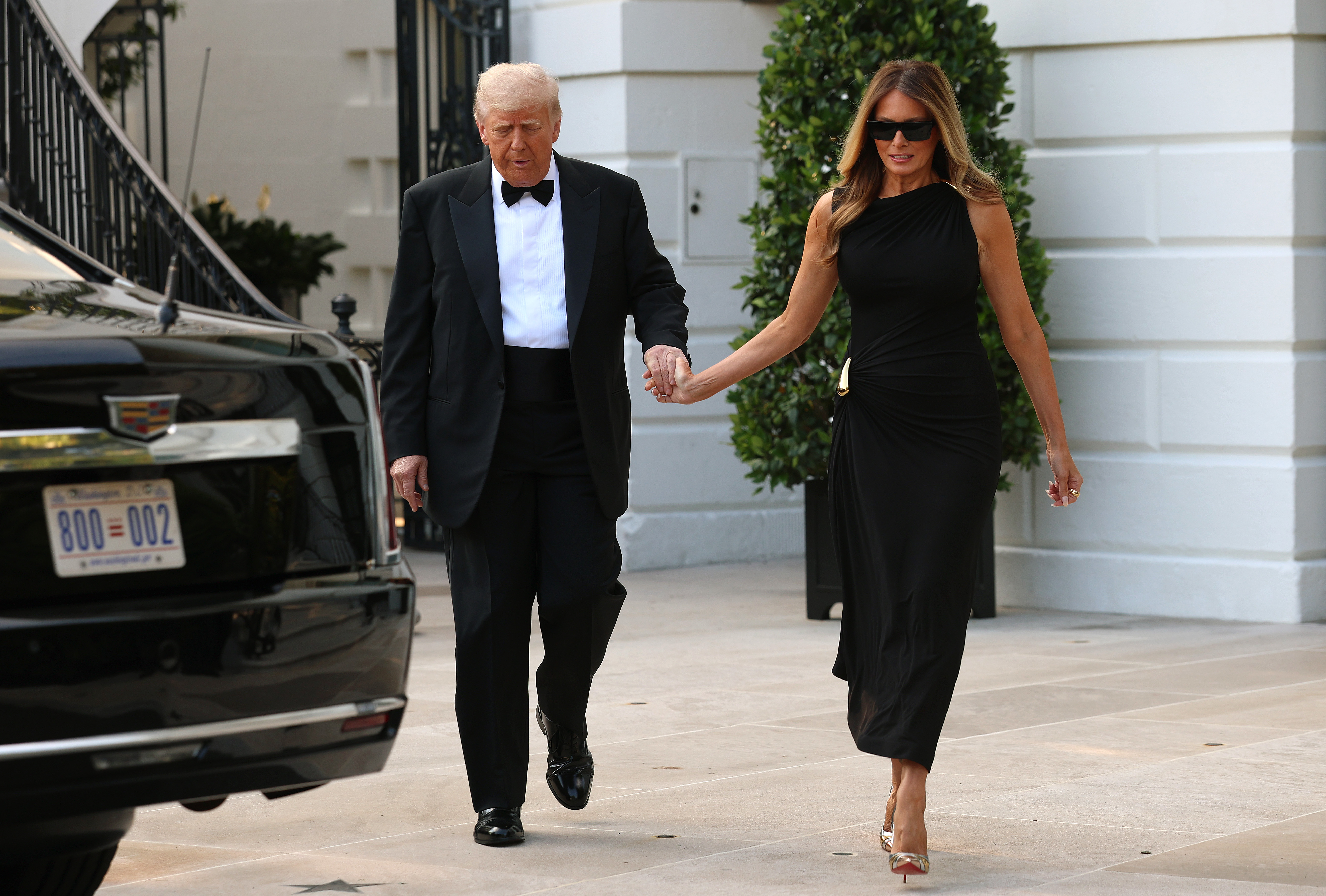 President Donald Trump and First Lady Melania Trump hold hands as they leave the White House on June 11, 2025, ahead of an evening performance of Les Misérables.