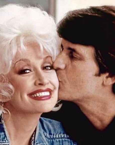 Dean leaned in to kiss Parton on the cheek as she smiled toward the camera in an affectionate portrait of the famously private couple. The close-up offered another rare look at the man who spent decades avoiding the attention surrounding his wife's career. Although their contrasting relationships with fame kept Dean largely unseen by the public, Parton said their marriage was built on mutual respect, admiration, and humor. | Source: Facebook/One Country