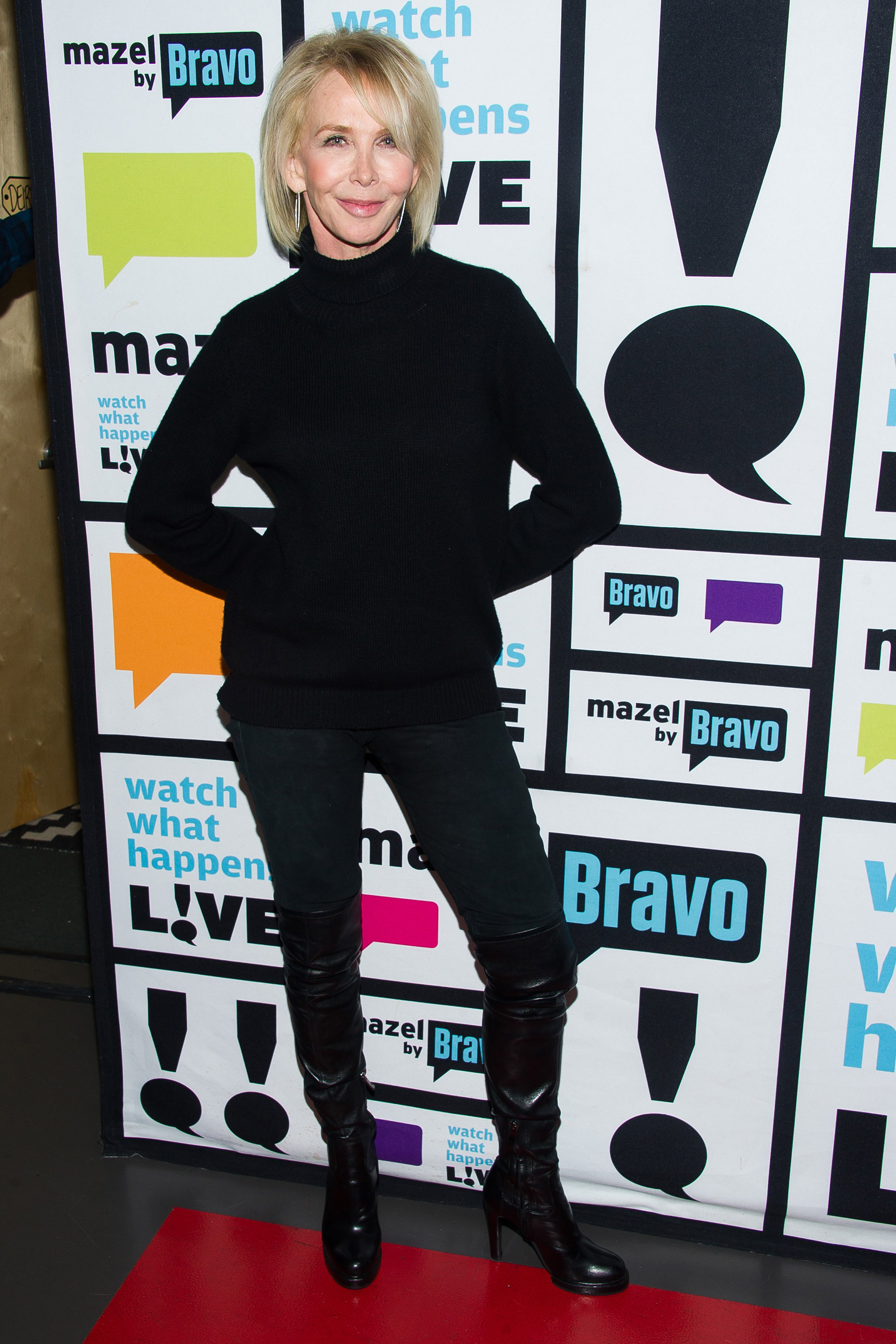 Trudie Styler, at 60, was photographed with a smooth, refined complexion framed by a straight, chin-length blonde bob, an elegant high neck, and a subtly uneven lip line holding a gentle smile, while attending "Watch What Happens Live" on December 18, 2014, in New York City.