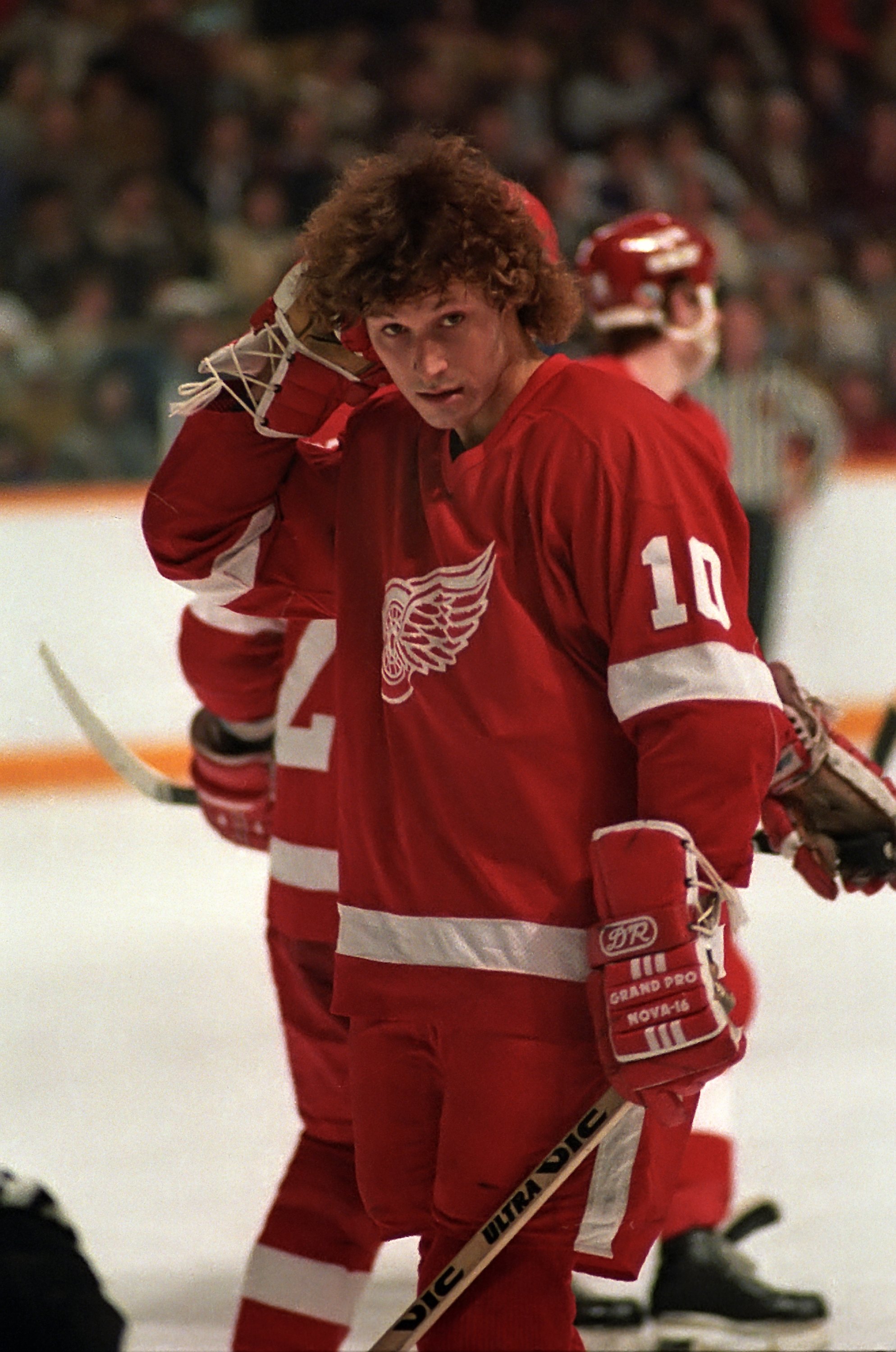 Duguay adjusts his hair during a break in a game against the Toronto Maple Leafs on February 19, 1984. His hairstyle became part of his public image, helping him stand out among NHL players of his era. | Source: Getty Images