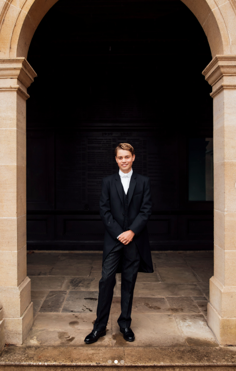 George posed beneath a stone archway in Eton’s formal tailcoat, waistcoat, and pinstriped trousers. The first-day portrait marked a sharp contrast with his earlier childhood school photos. | Source: Instagram/princeandprincessofwales