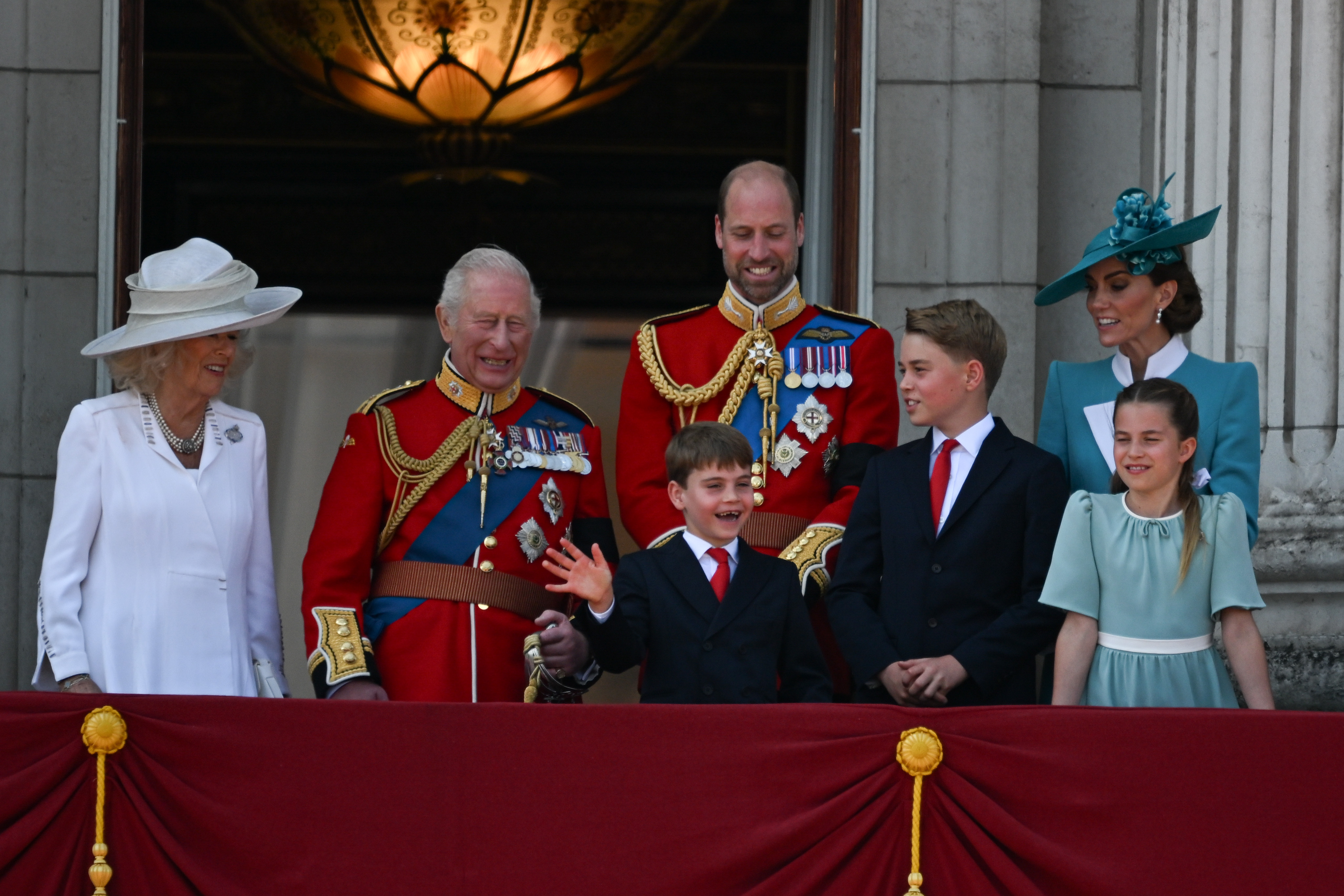 Queen Camilla, King Charles III, Prince William, Prince Louis, Prince George, Princess Catherine, and Princess Charlotte watching the Trooping the Colour festivities from the Buckingham Palace balcony. | Source: Getty Images