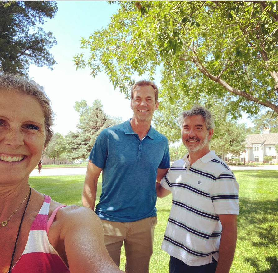Bryon Noem smiles alongside a visiting couple, while a woman leans into the frame to snap the selfie. | Source: Instagram/sdbryonnoem