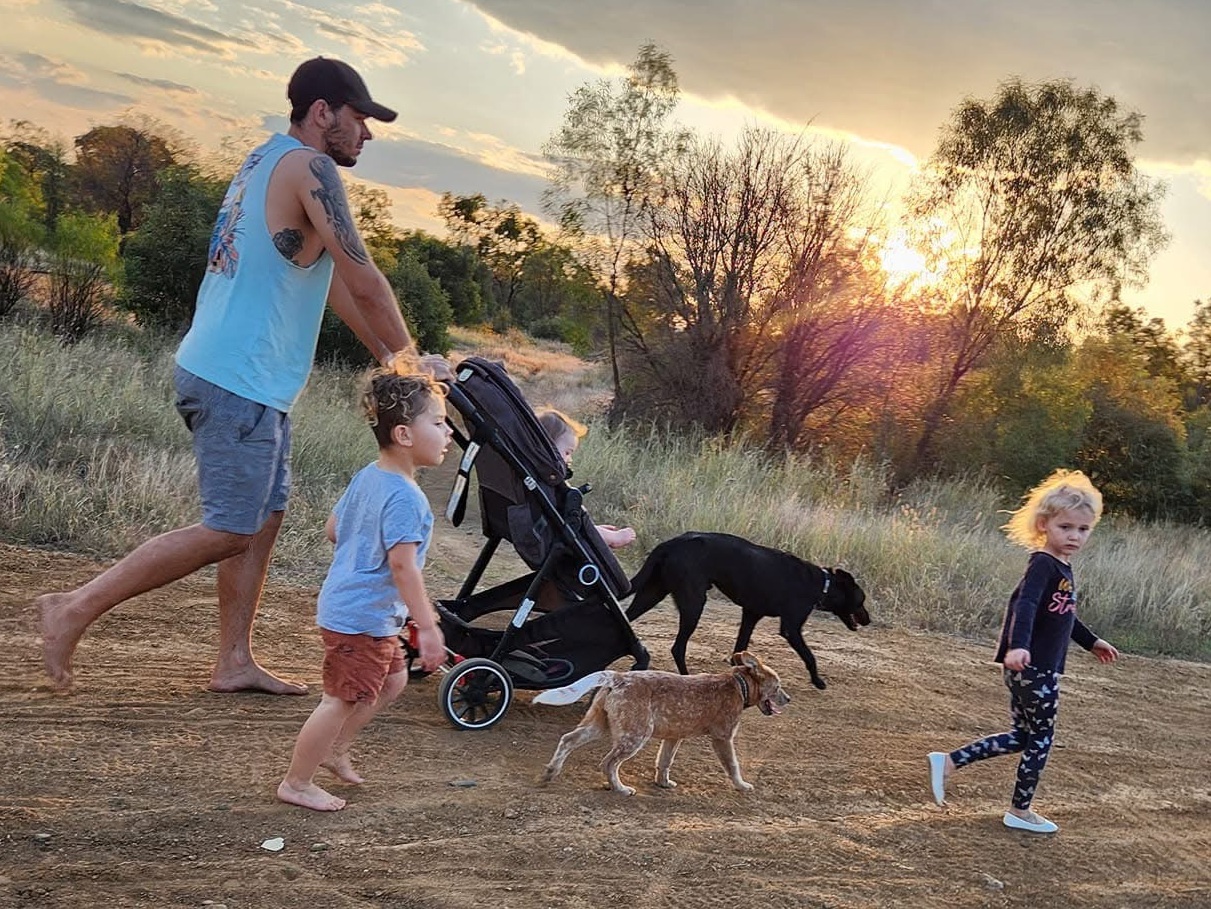 Shaun Ranger pushes a baby stroller at sunset accompanied by his children Chandler and Baylee and their dogs. | Source: GoFundMe