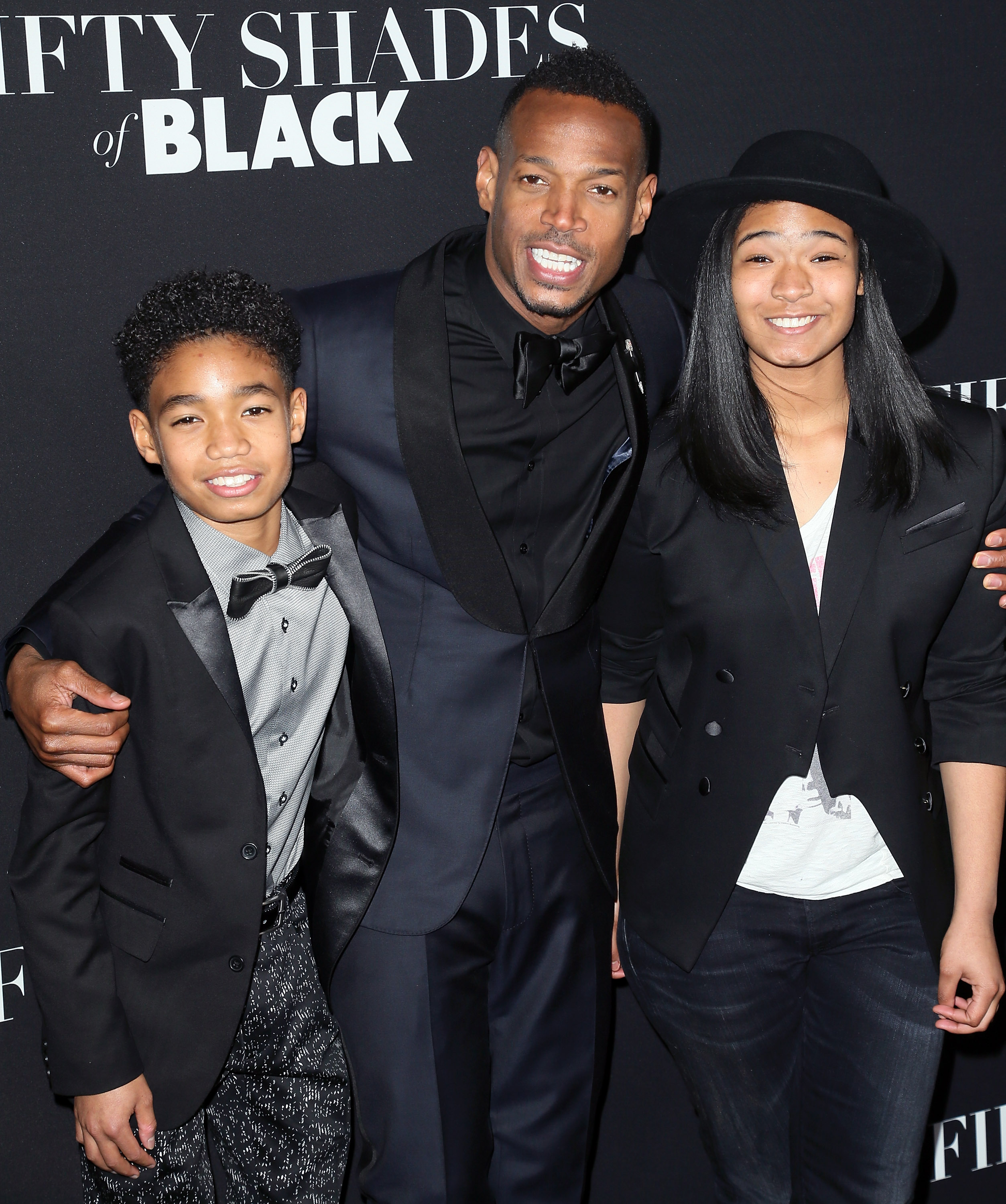 Marlon Wayans, Shawn Howell Wayans, and Kai Wayans attend the premiere of "Fifty Shades of Black" at Regal Cinemas L.A. Live on January 26, 2016, in Los Angeles, California | Source: Getty Images