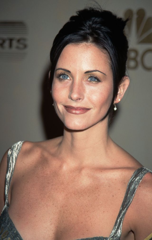 In 1997, at the height of "Friends" fame, Courteney Cox dazzles in a stunning silver dress, embodying the elegance of her Monica Geller era.