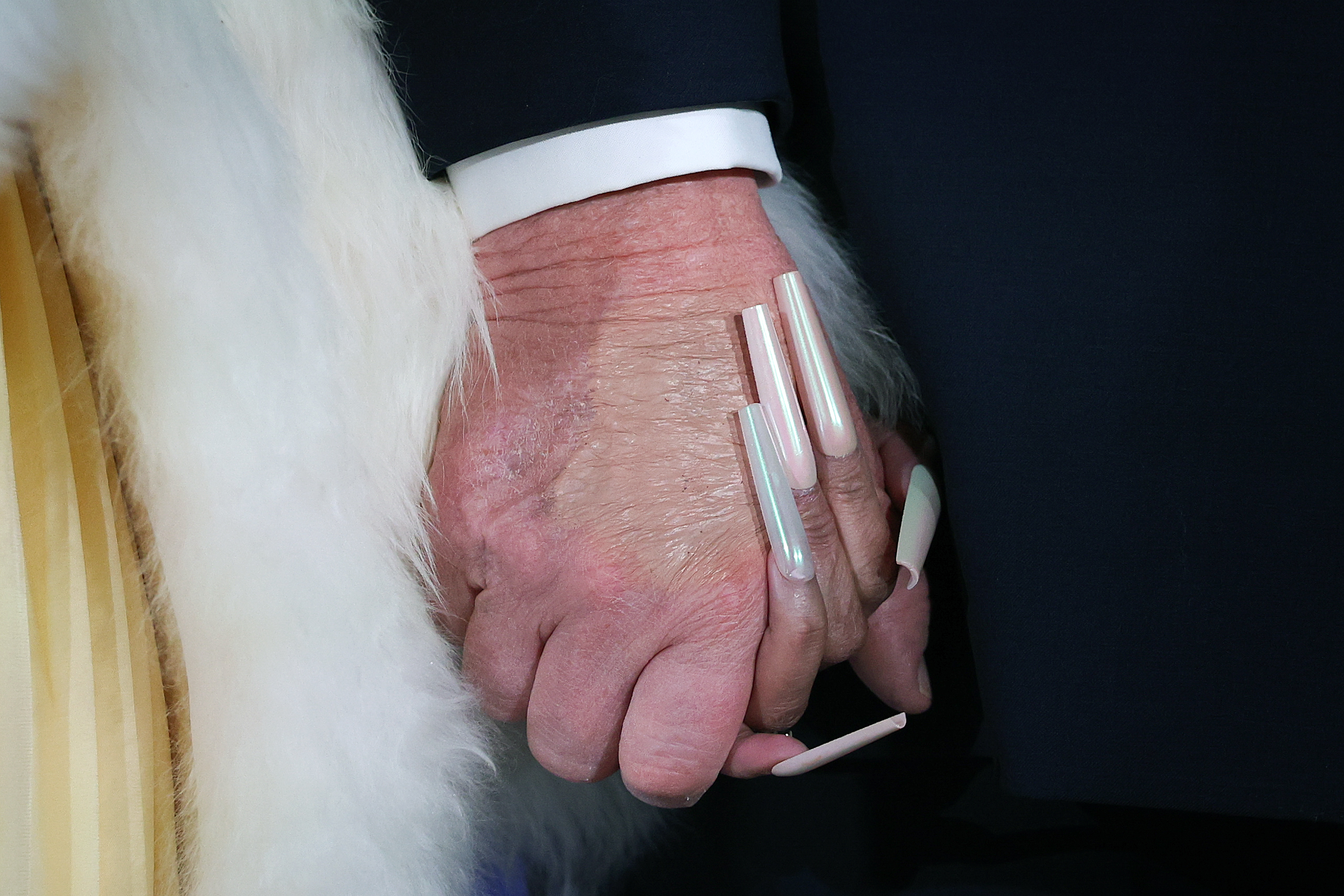 A close-up of Nicki Minaj and Donald Trump's hands clasped together in a hand hold. | Source: Getty Images
