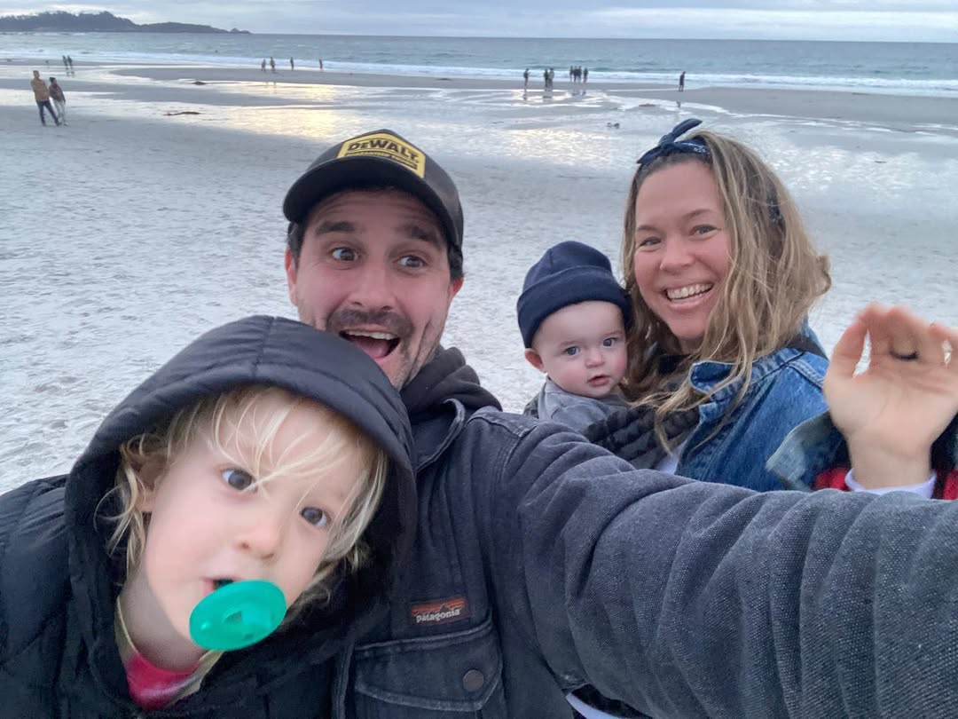 James Ransone and his wife Jamie McPhee hold their children Jack and CViolet as they take photo on the beach, from a post dated January 4, 2022. | Source: Instagram/skippermcphee