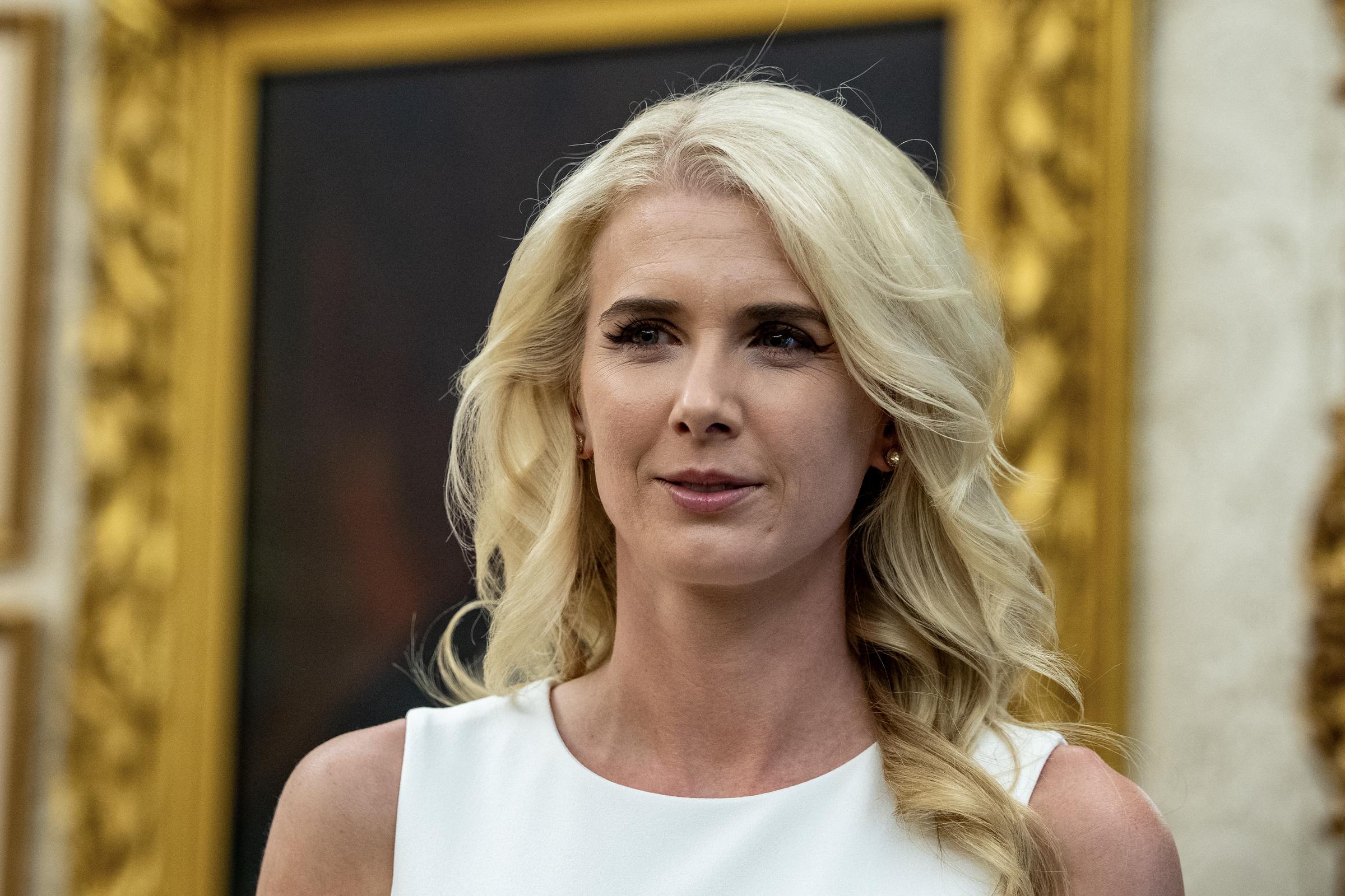 Natalie Harp, an aide to President Donald Trump, is pictured during her time in his political orbit. | Source: Getty Images