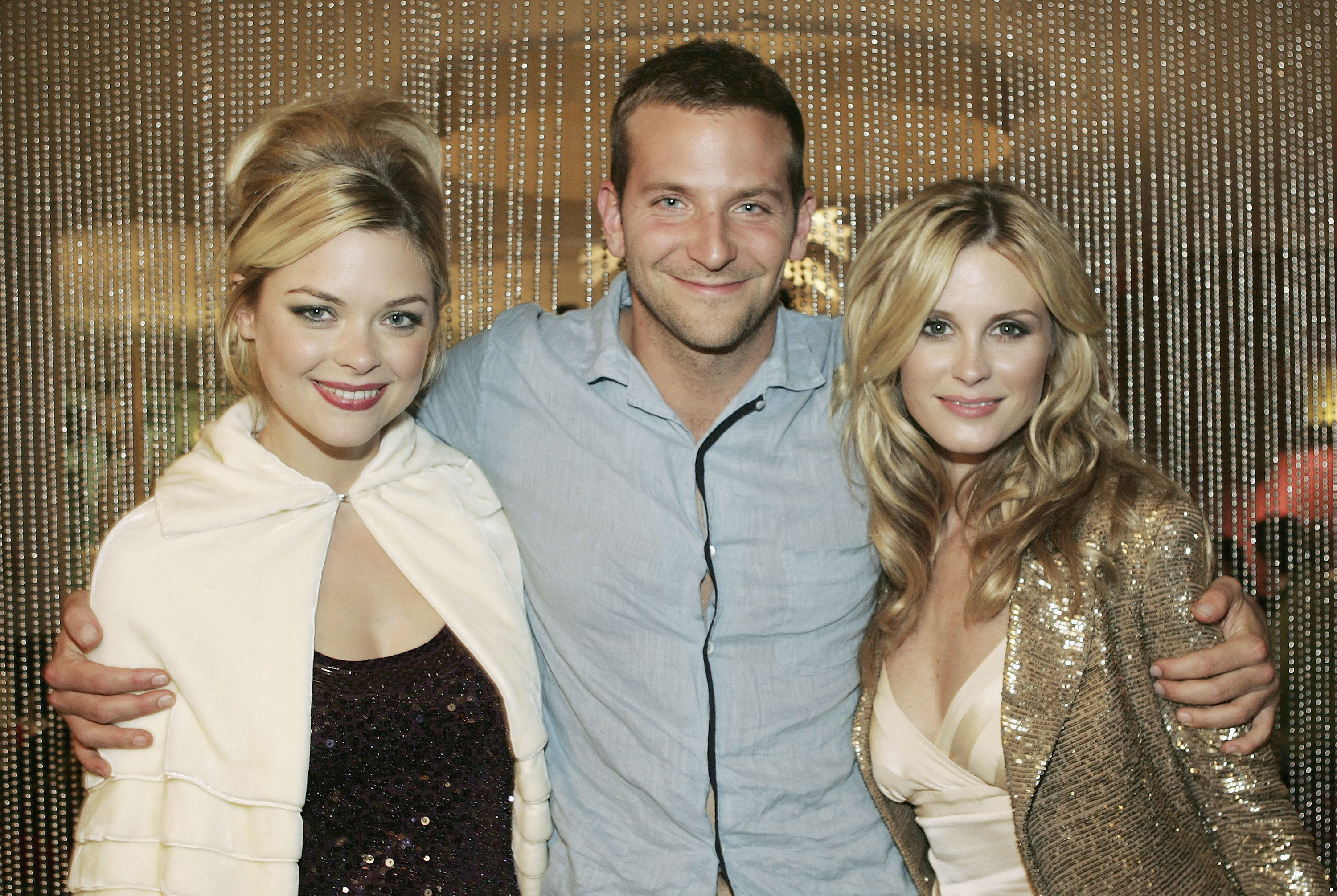 A few years later, Cooper, at 30, was still early in his career. He maintained a youthful face, short, light brown hair, and slight stubble as he wrapped his arms around actresses Jaime King and Bonnie Somerville, at Movieline's "Kitchen Confidential" party at Hollywood Life's Young Hollywood House at The Pacific Design Center on October 8, 2005, in Los Angeles, California.