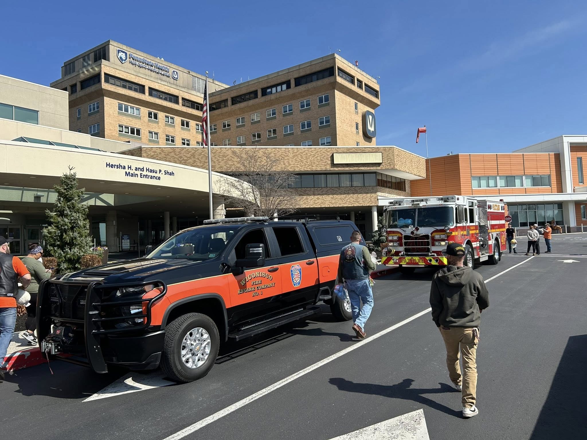 Emergency vehicles sit outside the main entrance of Penn State Health Holy Spirit Medical Center in Camp Hill, Pennsylvania. Following desperate lifesaving efforts on her front lawn, first responders rushed Dr. Julia Pederson to this hospital on October 10, 2026, where the beloved pediatrician and mother of a 7-year-old daughter was tragically pronounced dead before investigators uncovered evidence of foul play. | Source: Facebook/Penn State Health Holy Spirit Medical Center