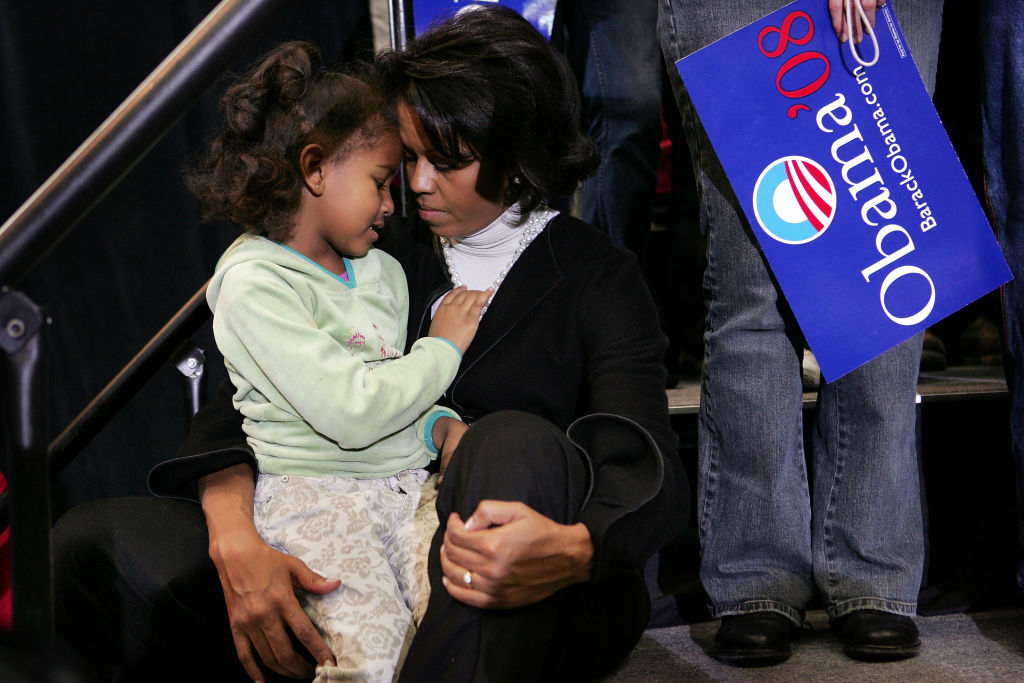 During a campaign rally on February 11, 2007, in Ames, Iowa, Sasha Obama, bundled in a red coat, rested on Michelle's lap as Barack addressed supporters at Iowa State University after launching his presidential run.