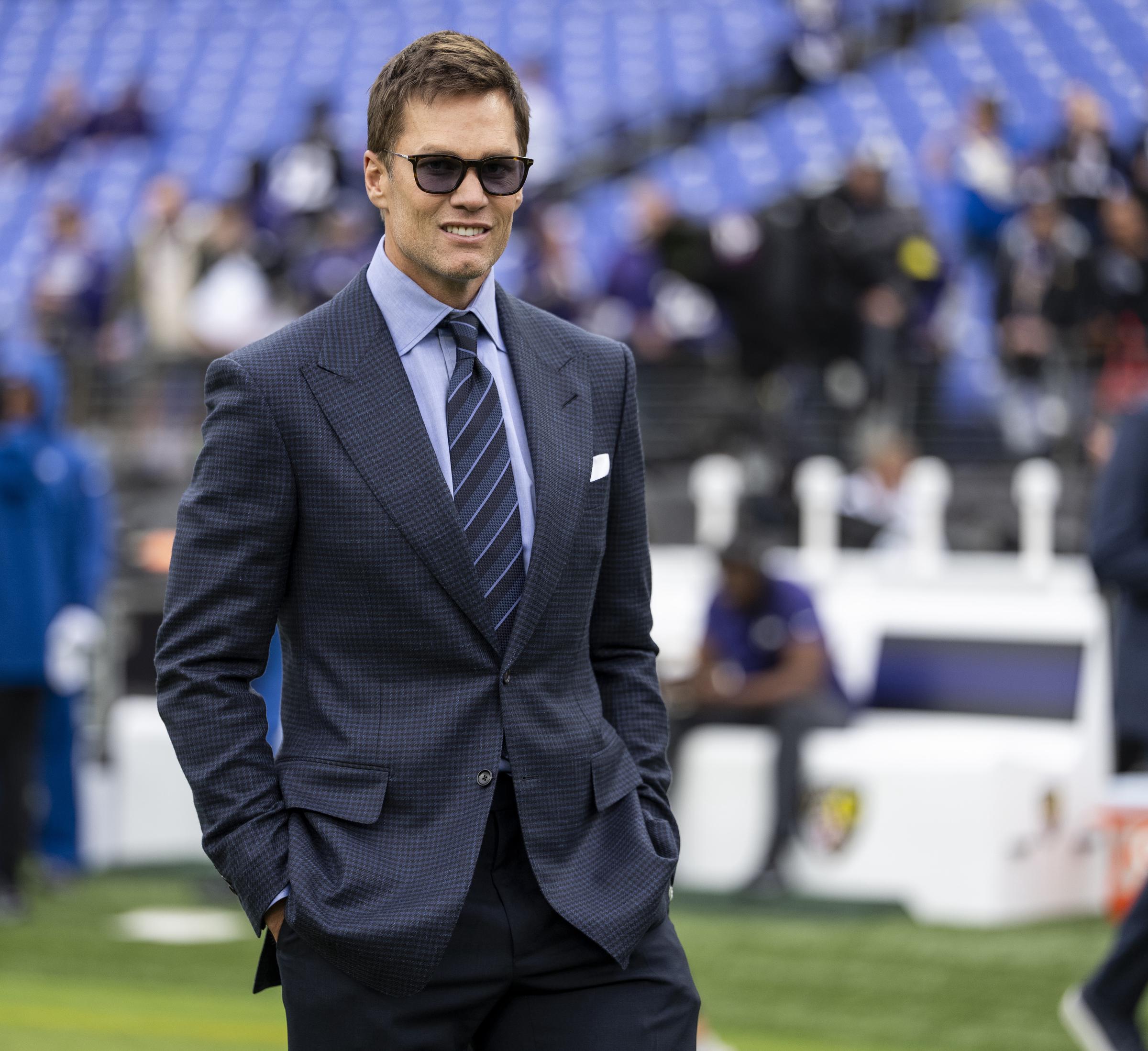 Tom Brady arrived at a 2025 NFL game in Baltimore wearing a tailored suit and sunglasses during his post-playing career transition.