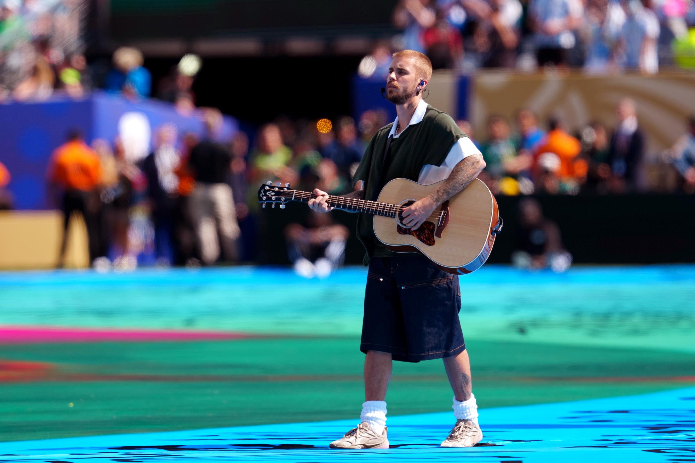 Justin Bieber took a more stripped-back approach, performing with an acoustic guitar in a set that emphasized vocals over elaborate staging. The contrast in presentation became one of the most talked-about aspects of FIFA's inaugural halftime show. | Source: Getty Images